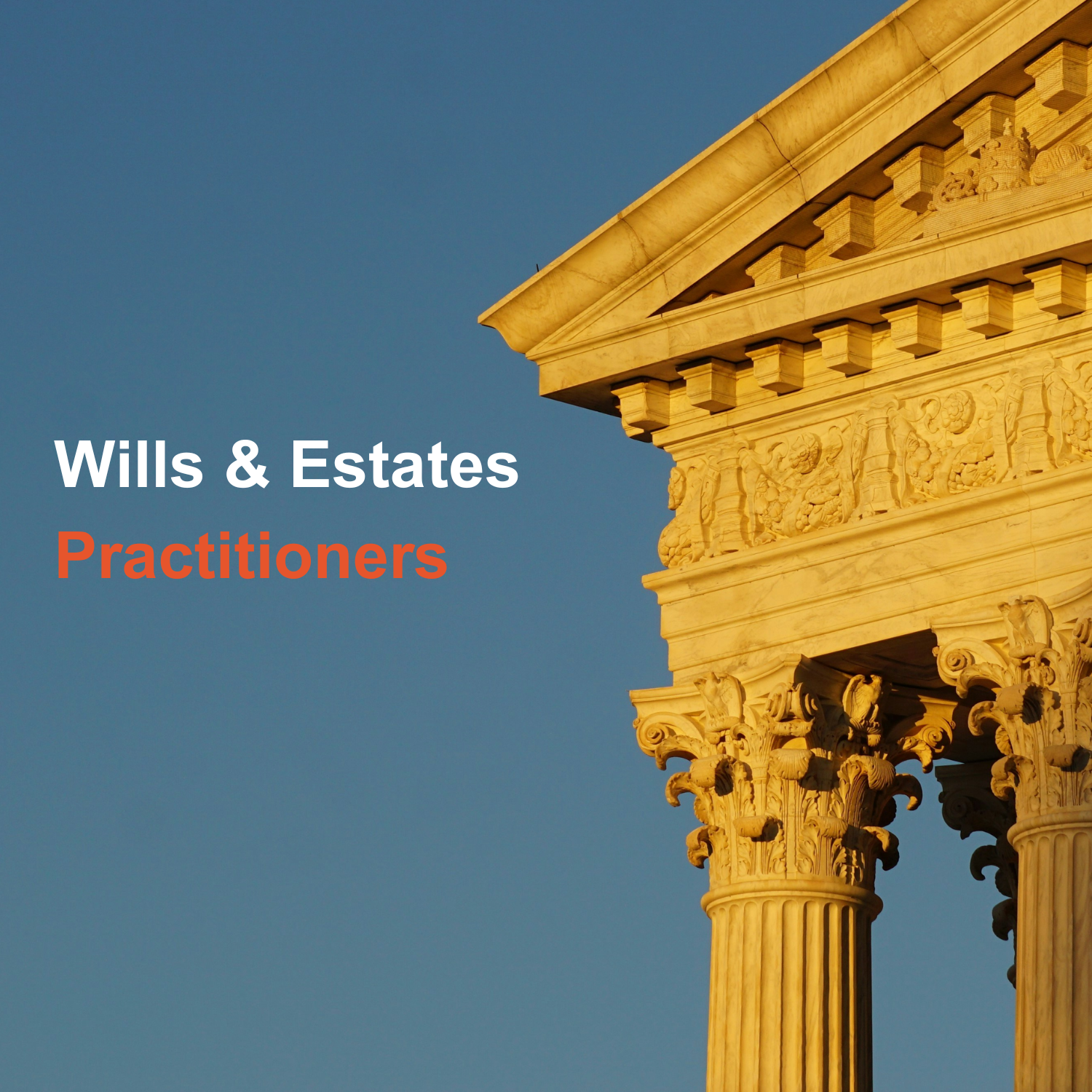 Close-up of classical architectural columns and decorative friezes with a blue sky background.