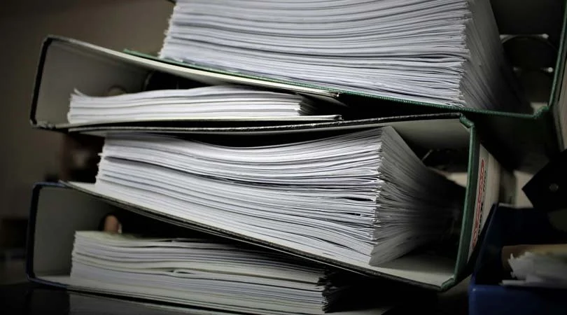 Spines of large Canadian tax law books symbolizing complexity of reclaiming unclaimed property