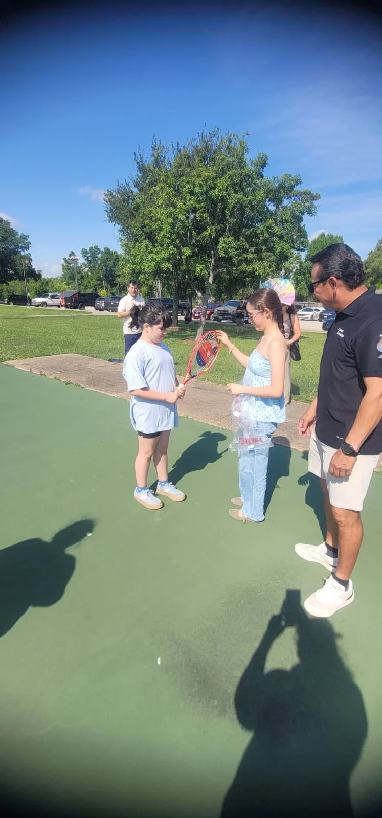 Free youth tennis racquets provided during community clinic in Houston
