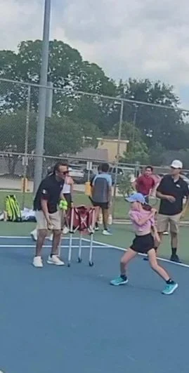 Young tennis player participating in Houston youth clinic