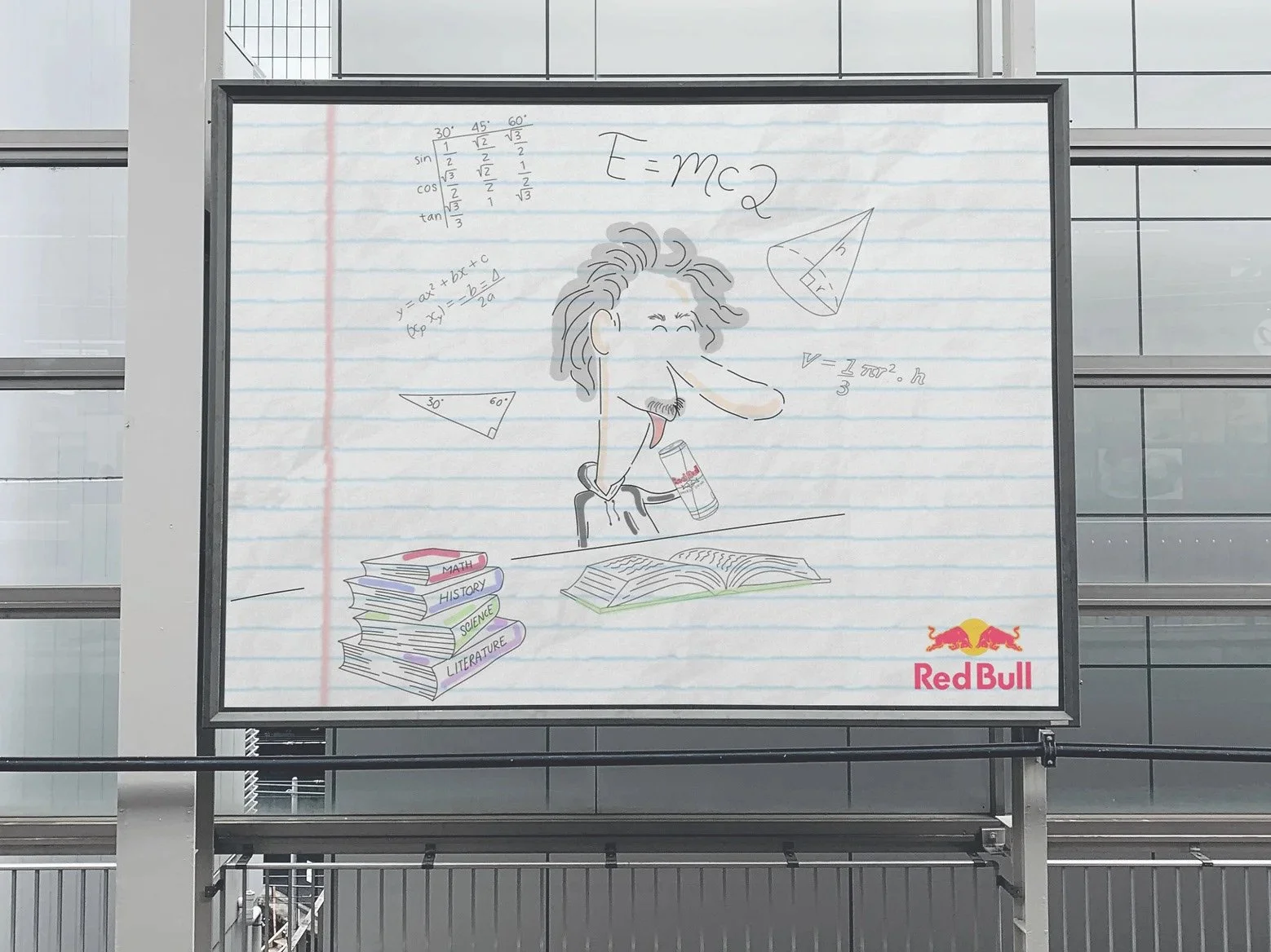 Billboard illustration with a cartoon character drinking Red Bull, surrounded by math equations and books, featuring the Red Bull logo.