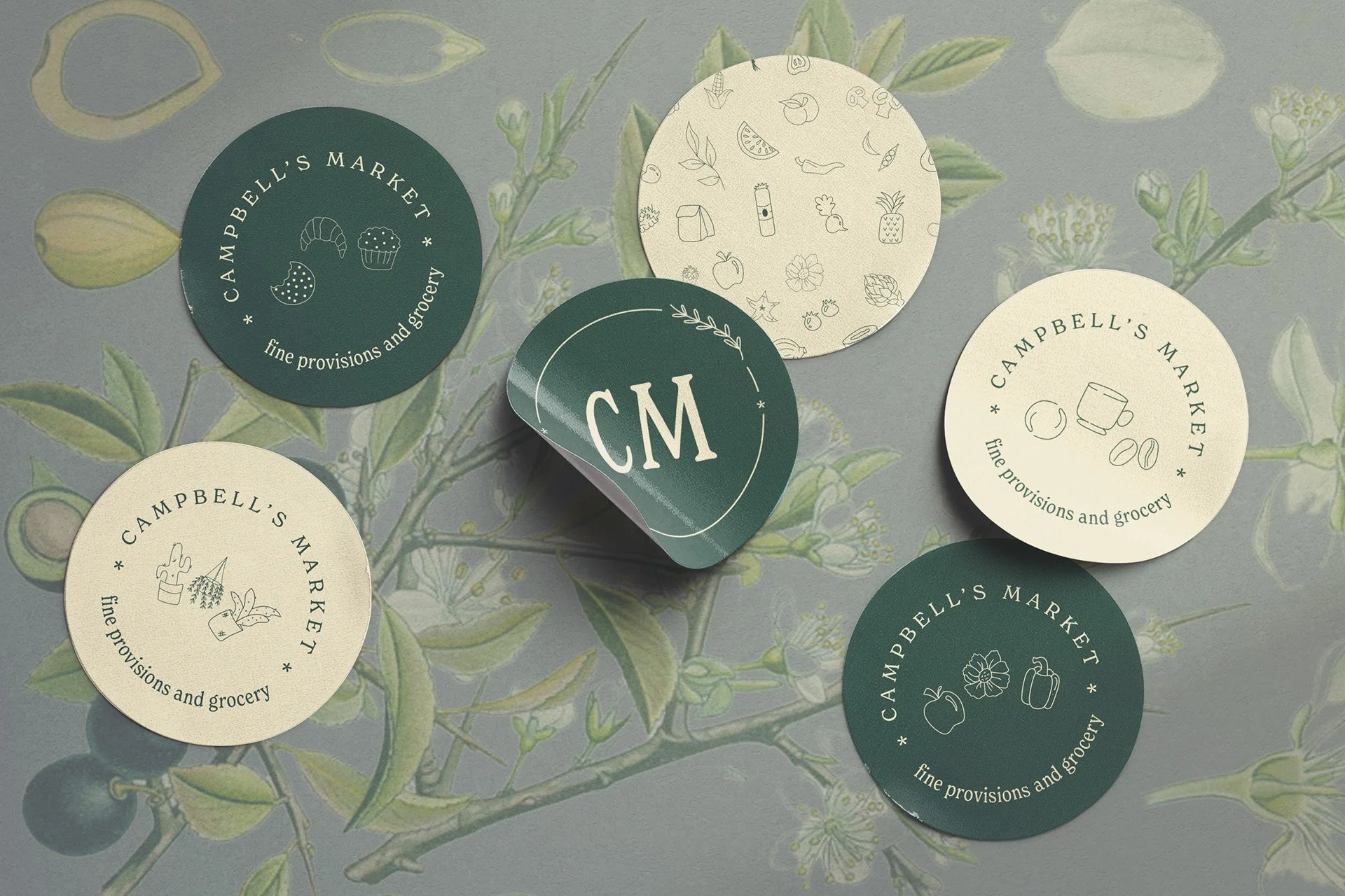 Circular stickers with "Campbell's Market" logo, featuring illustrations of food items and the phrase "fine provisions and grocery." Background has a botanical pattern.