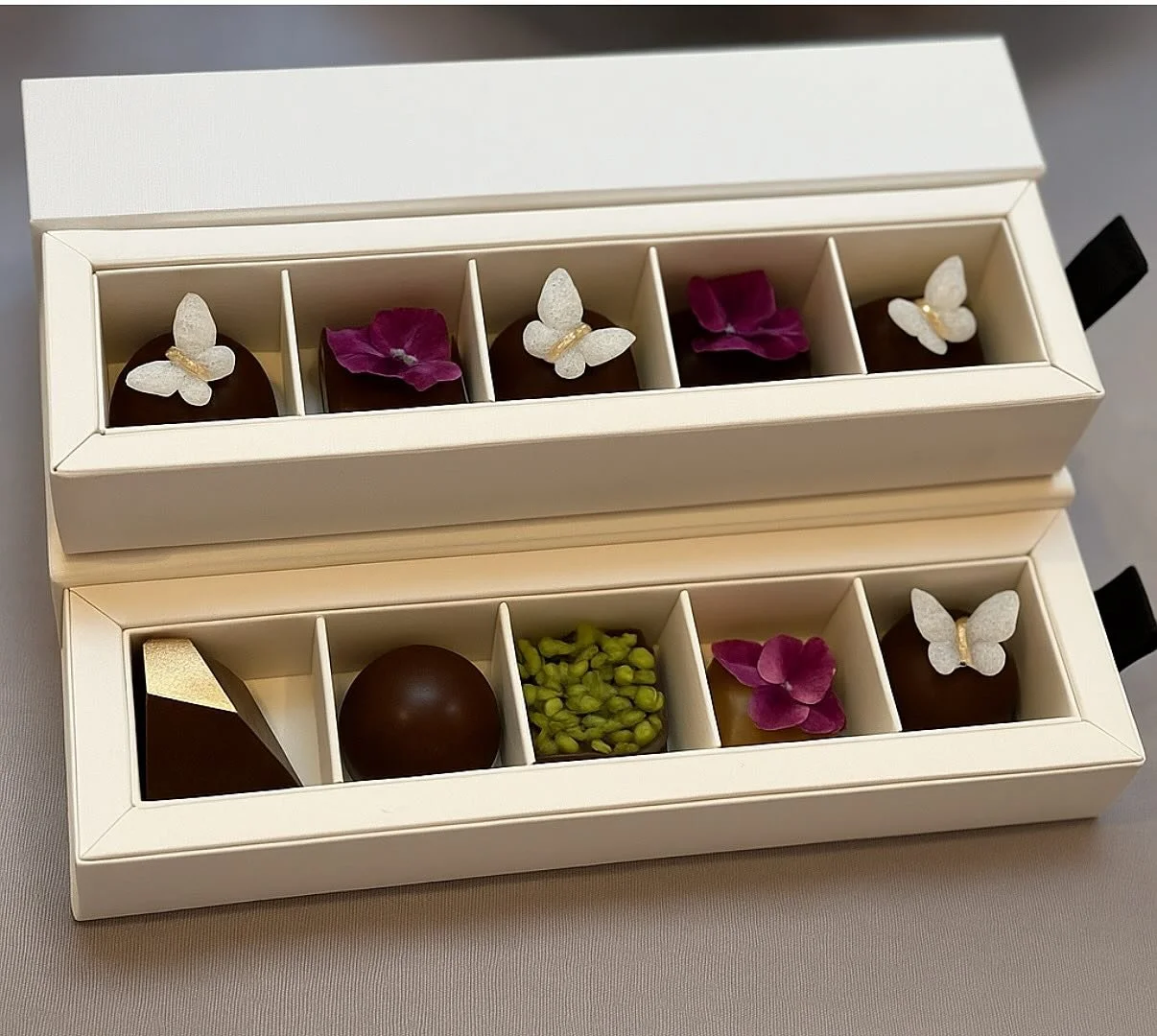 Each of these truffles is a story&mdash;crafted with intention, beauty, and heart. 💝
@rairechocolate was born from a moment of compassion: a handmade truffle recipe created to comfort a friend battling cancer. Now, each piece honors joy, connection,
