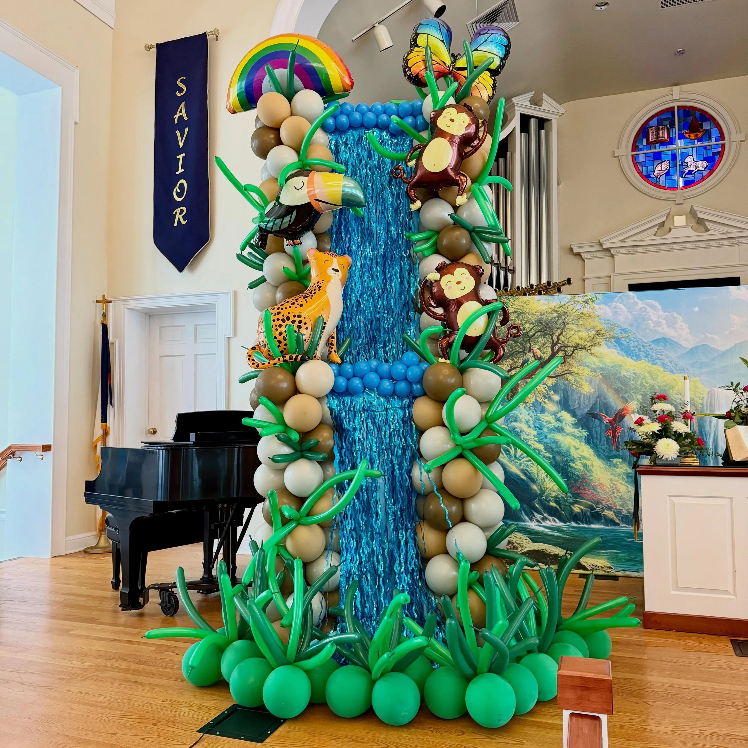 Church of the Lakes Rainforest Falls VBS. We brought the wild with a balloon waterfall, balloon ceiling vines, a photo backdrop, palm trees popping up and more! The jungle theme was such fun!
#balloondecor #jungletheme #vbs
#balloonartist #ballooncol