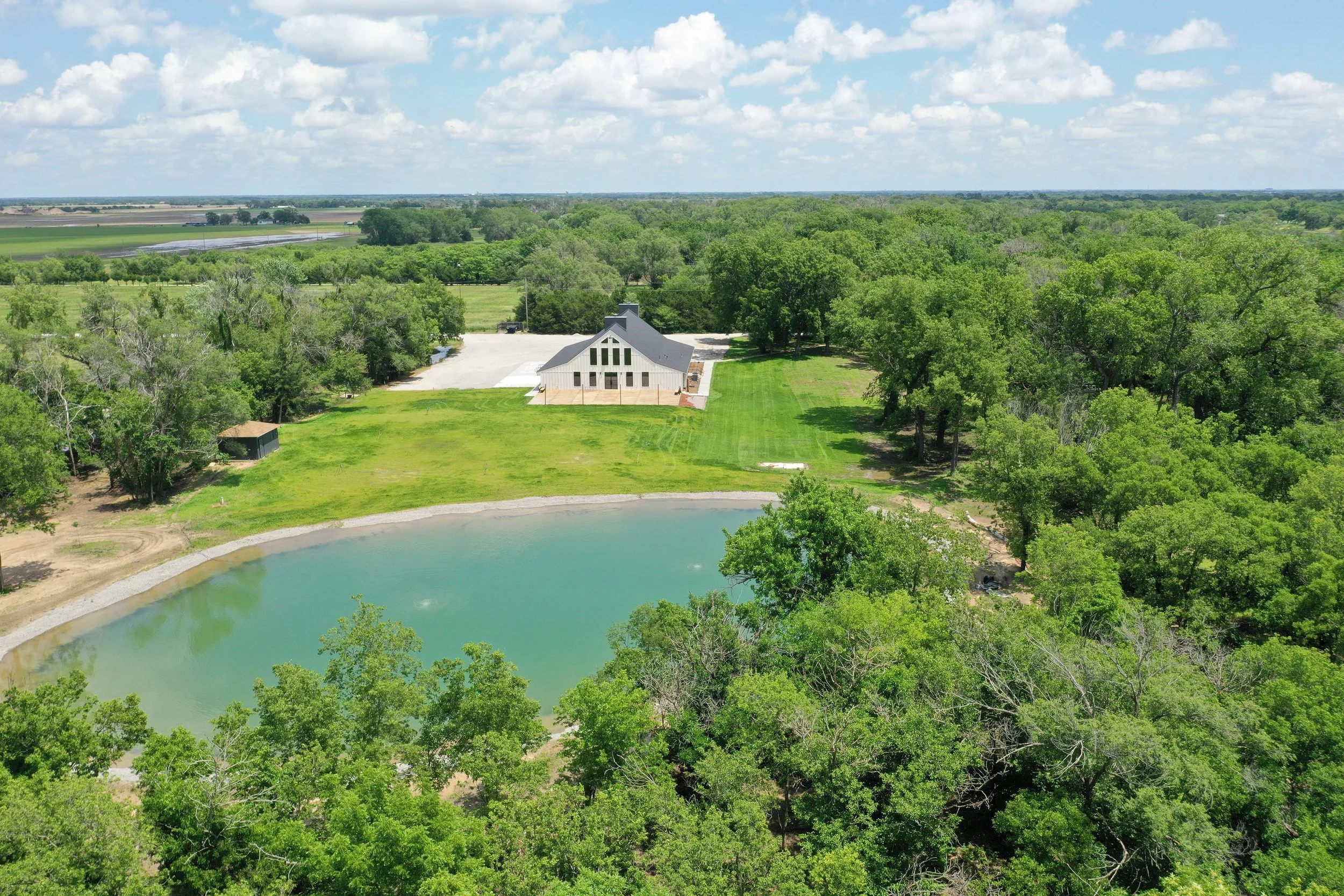 Exterior drone pic - pond and building.JPG