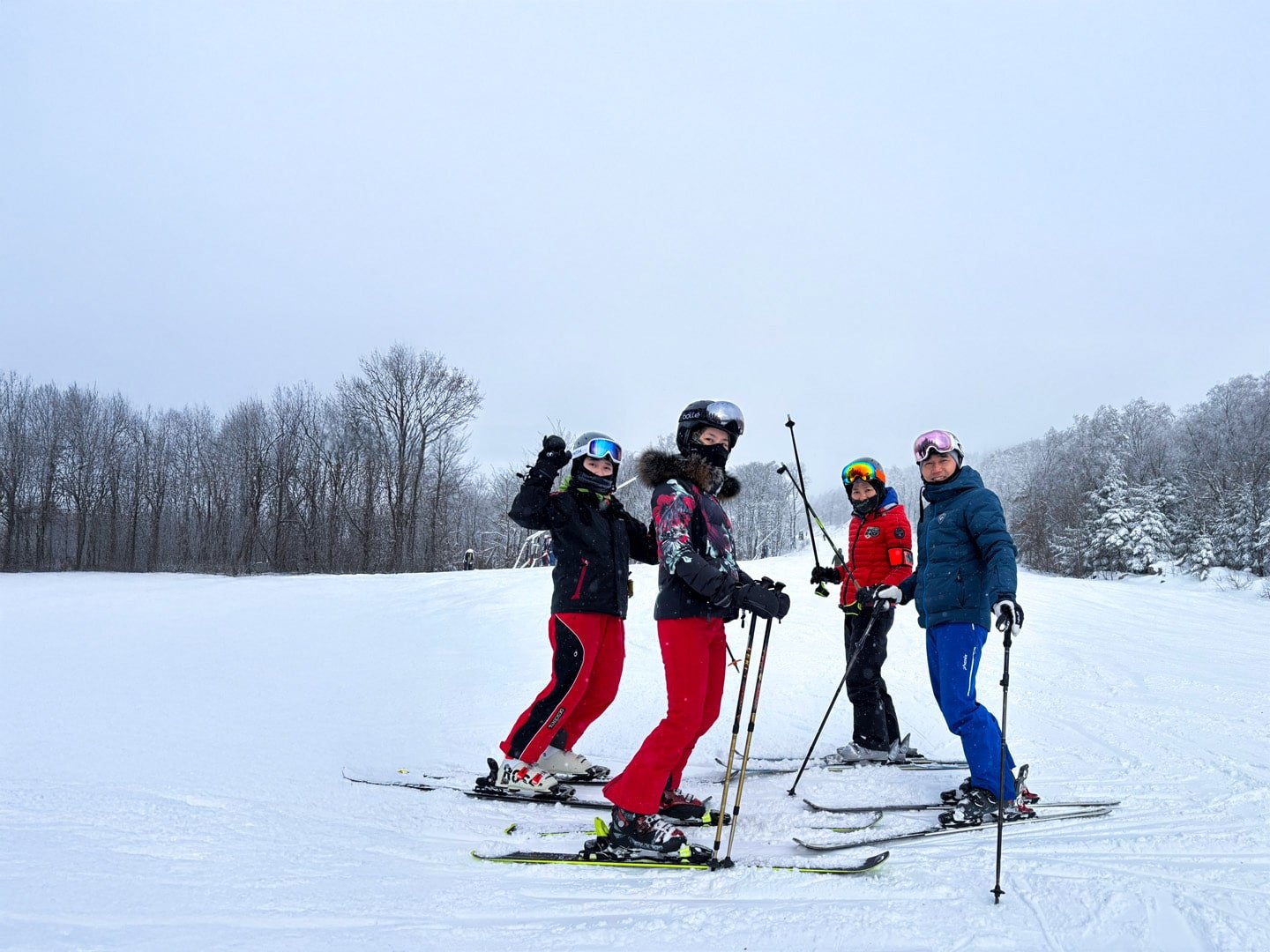 group of skier with poles waving at camera