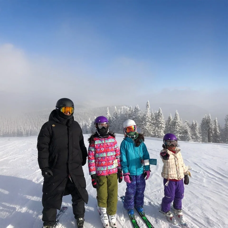 four skiers on ski slope