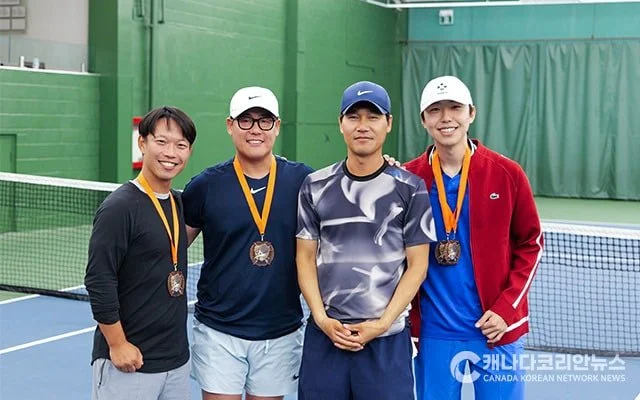 three toronto tennis students wearing medals standing next to tennis coach