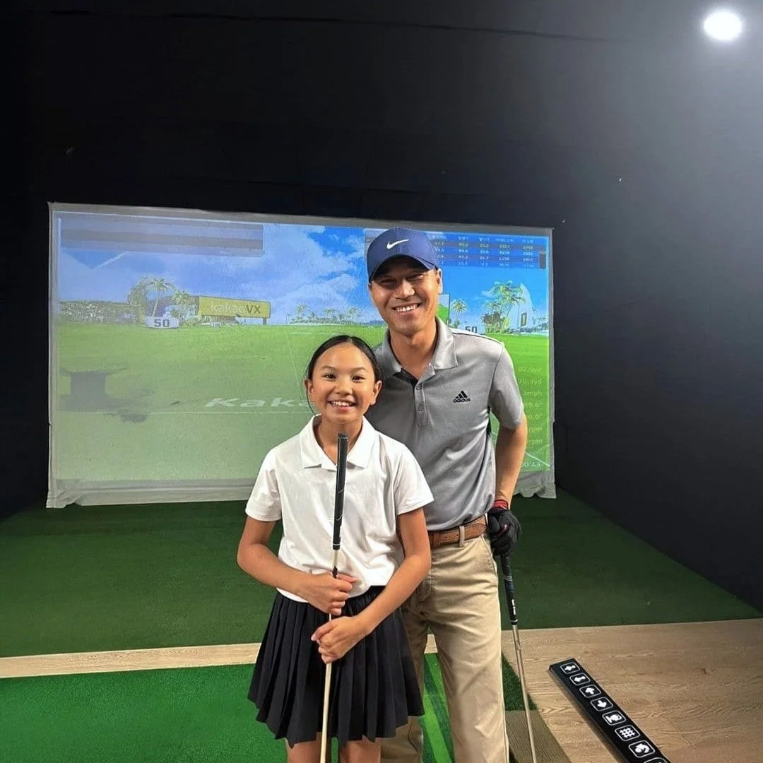 female golf student posing with her golf coach