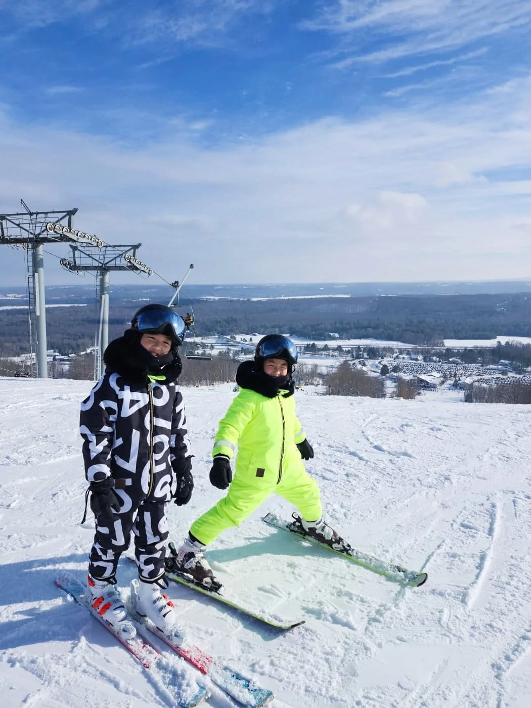 two ski students at the top of a ski slope