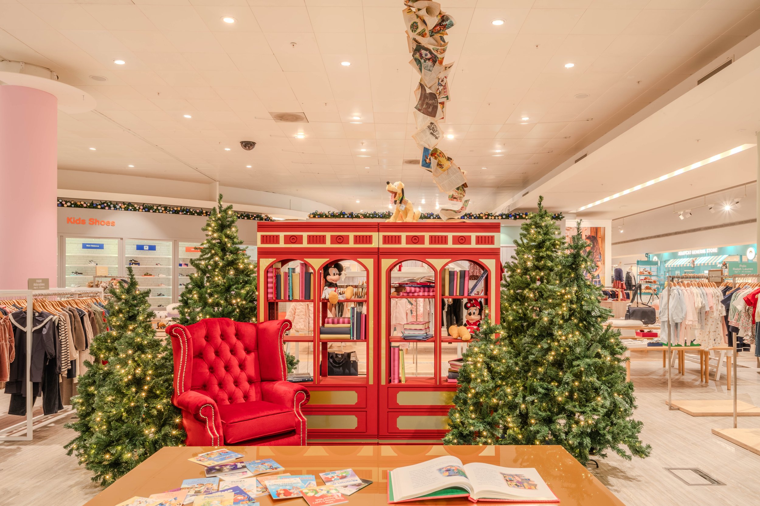 Selfridges x Disney Christmas installation — wide shot of seating area with Santa and table for writing letters to Santa, London commercial environment and brand space photography for retail marketing