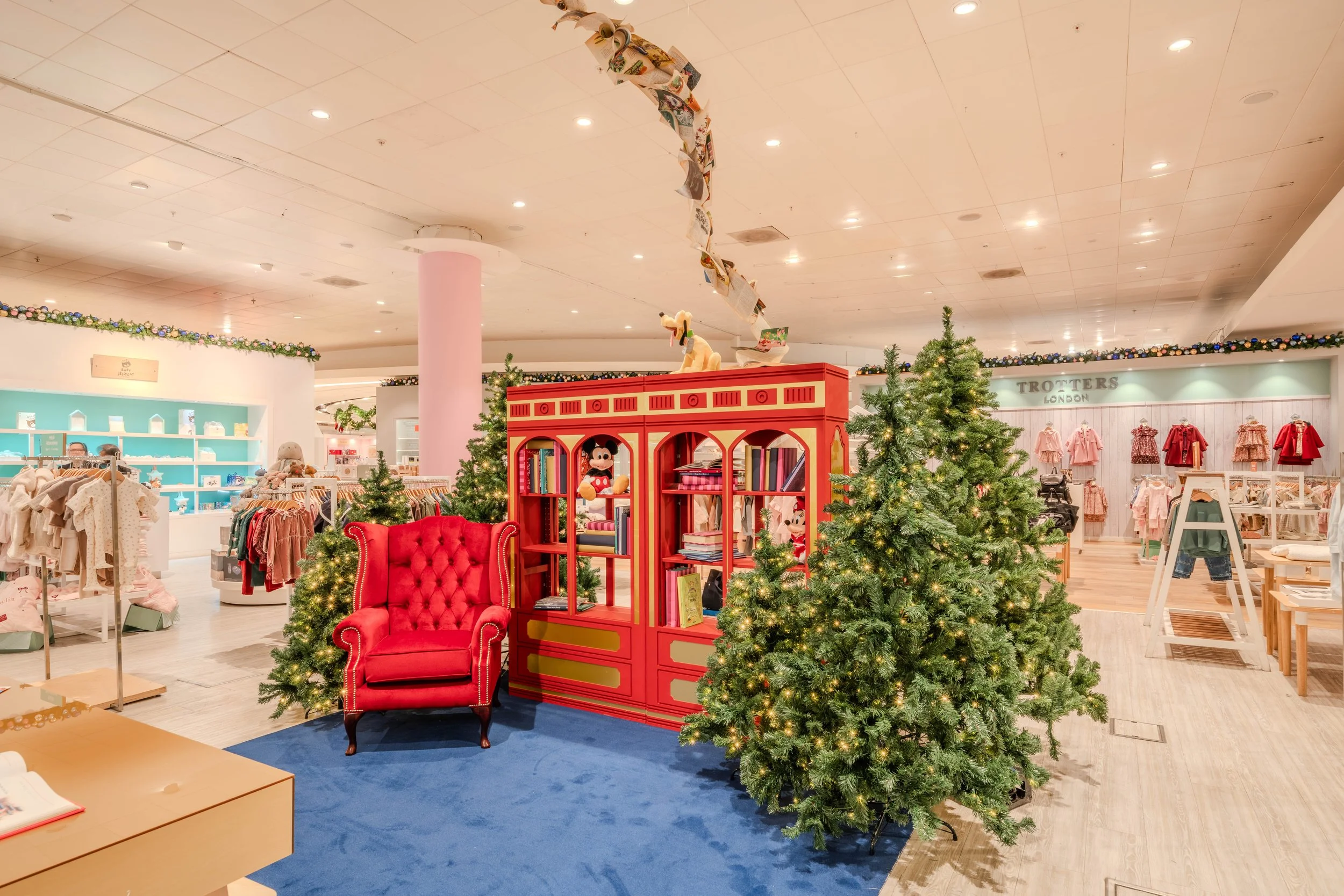Selfridges x Disney Christmas installation — wide shot of seating area with Santa and table for writing letters to Santa, London commercial environment and brand space photography for retail marketing
