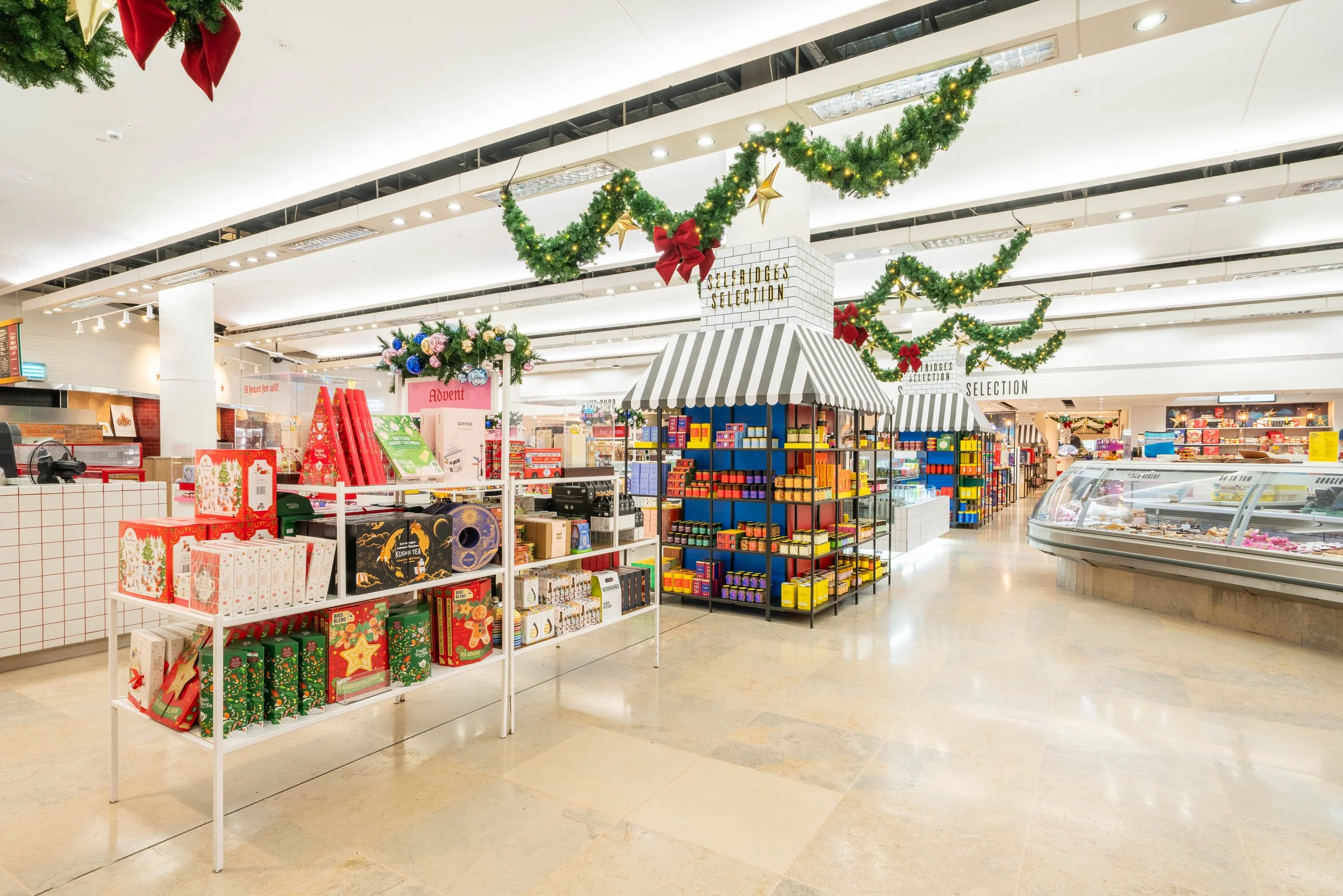 Selfridges x Disney Christmas installation — wide shot of the food hall counter with festive decorations, London commercial environment and brand space photography for retail marketing