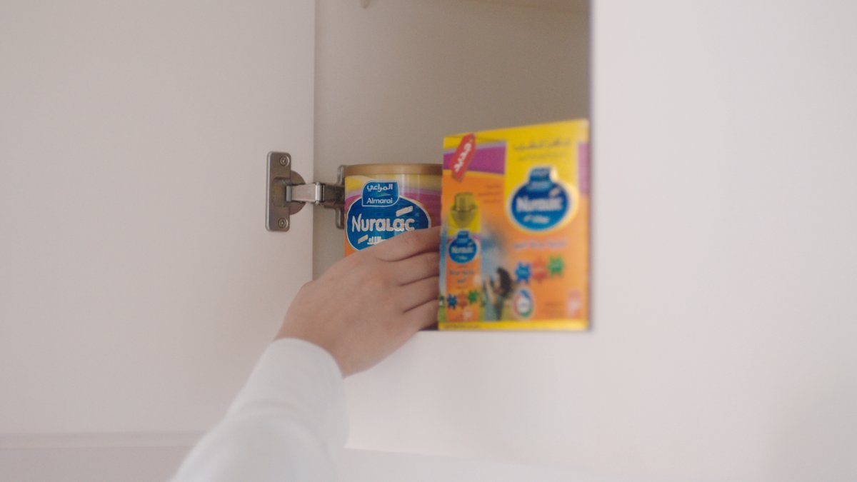 SHOT 8
In the kitchen, she opens a cupboard revealing a Pupford dog food bag.