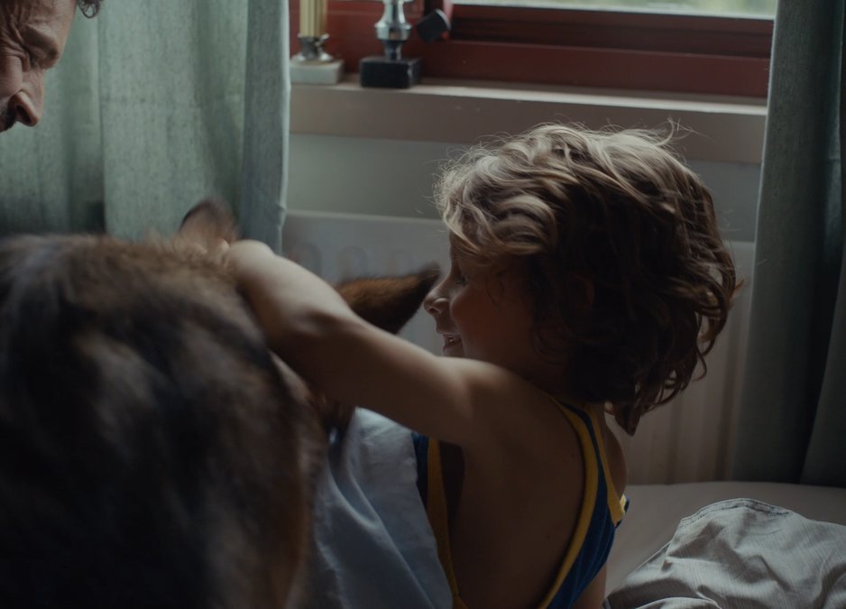 SHOT 28
Night: kids cuddle Charlie on couch.