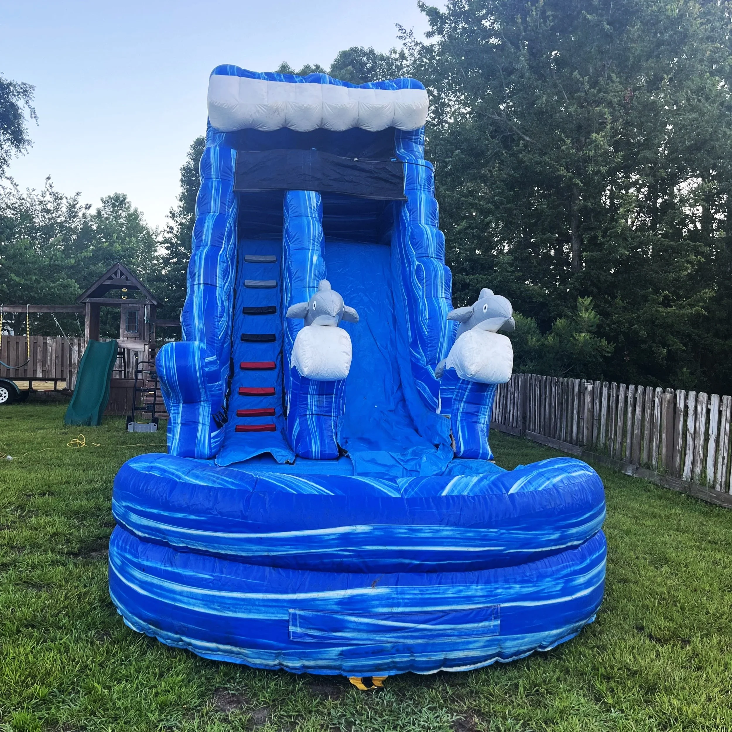Front view of the Big Flipper waterslide featuring a bold blue wave design and splash landing.