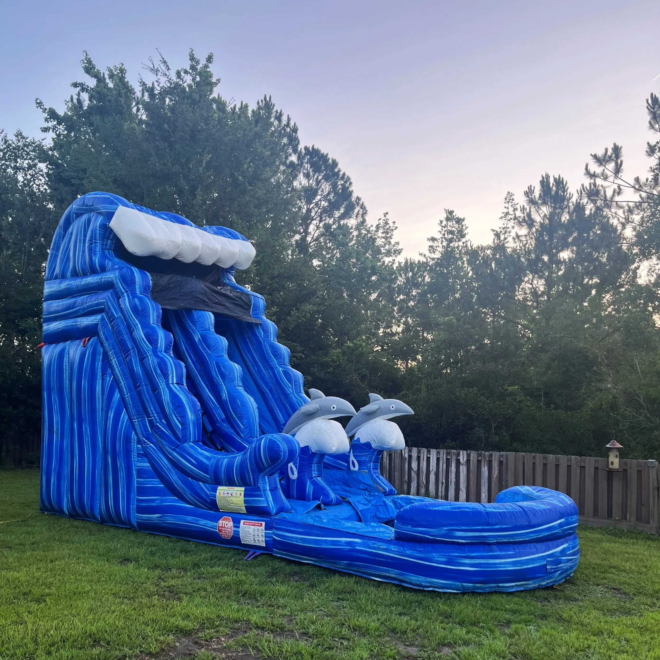Side angle of the Big Flipper 18-ft waterslide showing wide climbing steps and smooth slide lane.