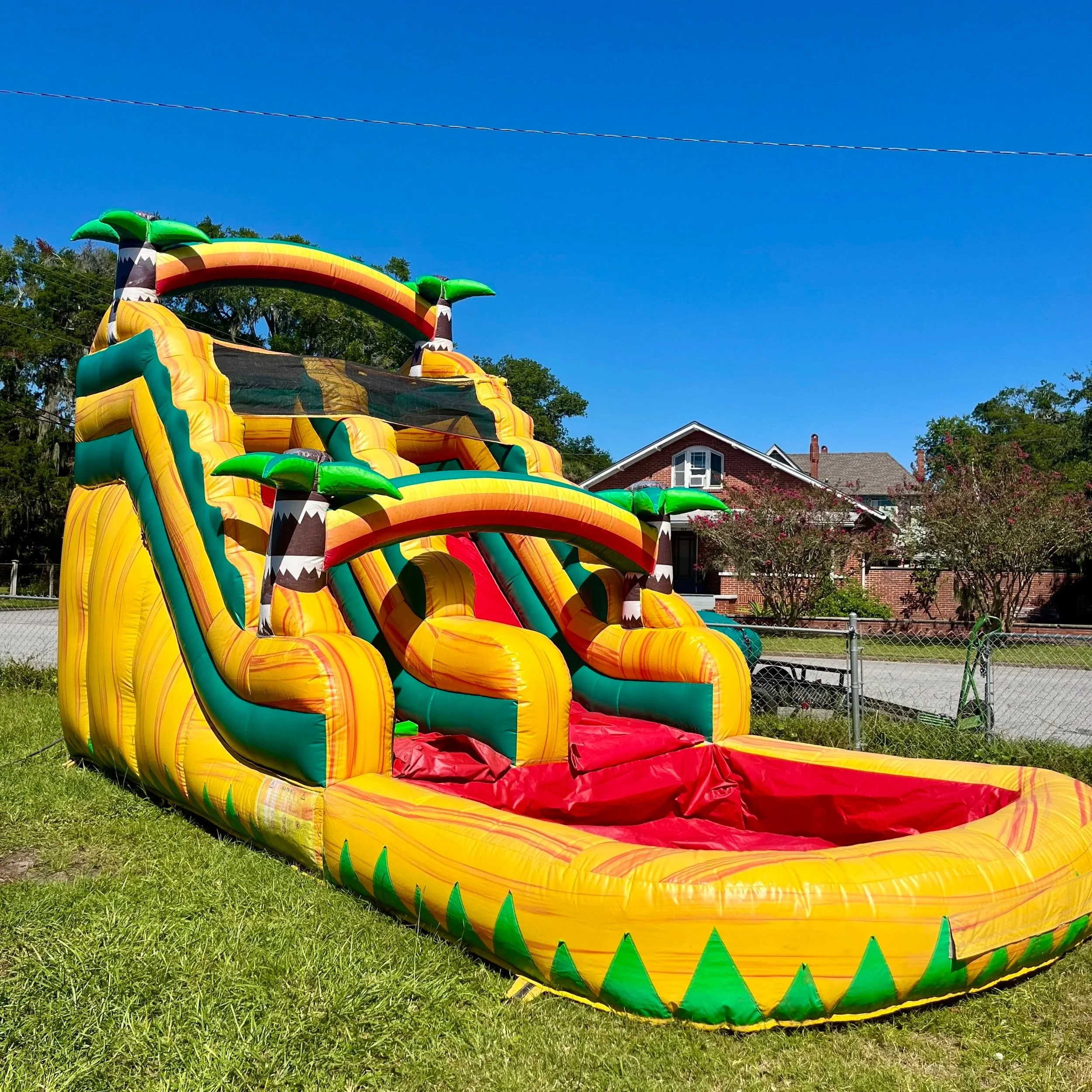Backyard setup of Sunshine Falls waterslide in Coastal Georgia with palm-inspired tropical design.