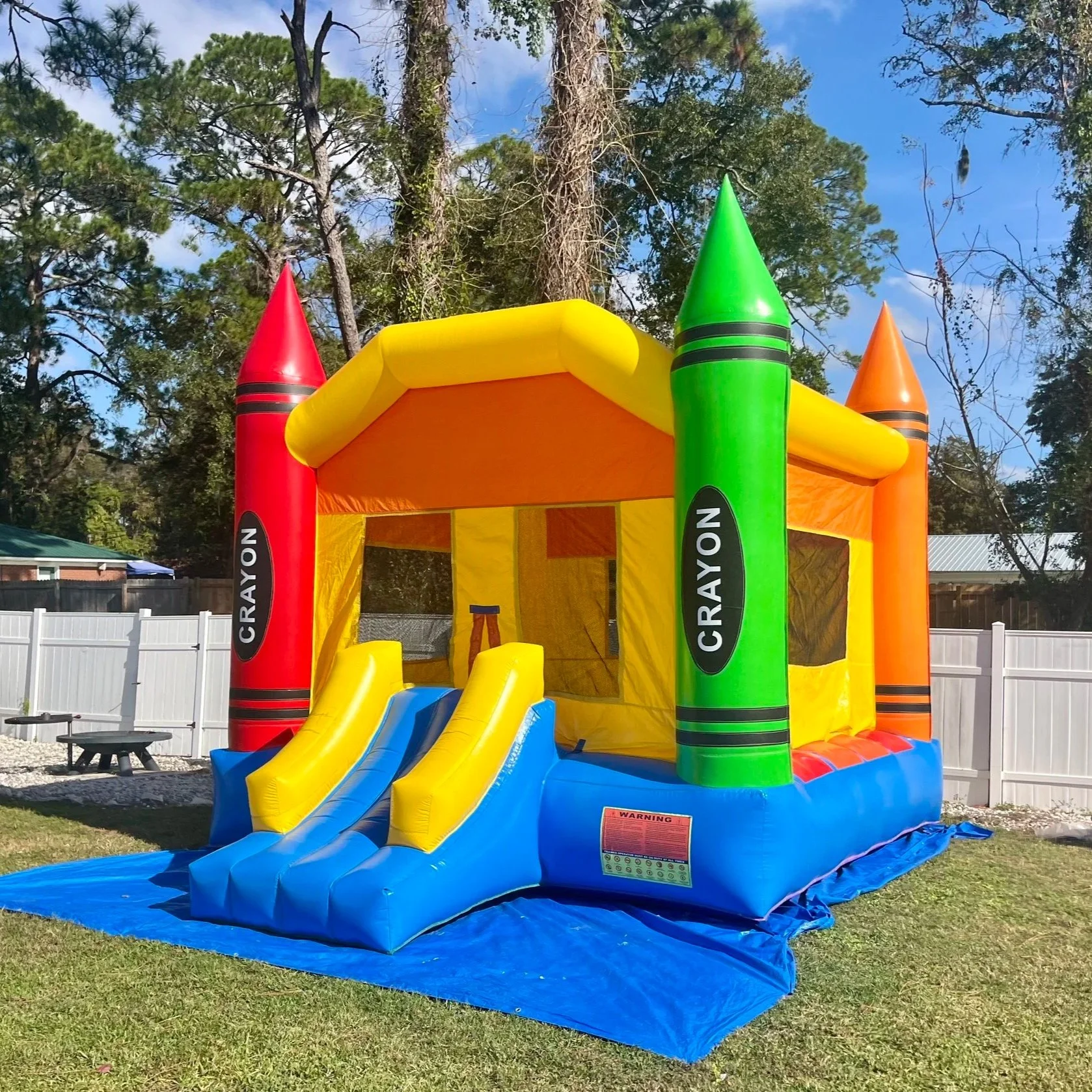 Crayon Castle toddler bounce house rental in a residential backyard.