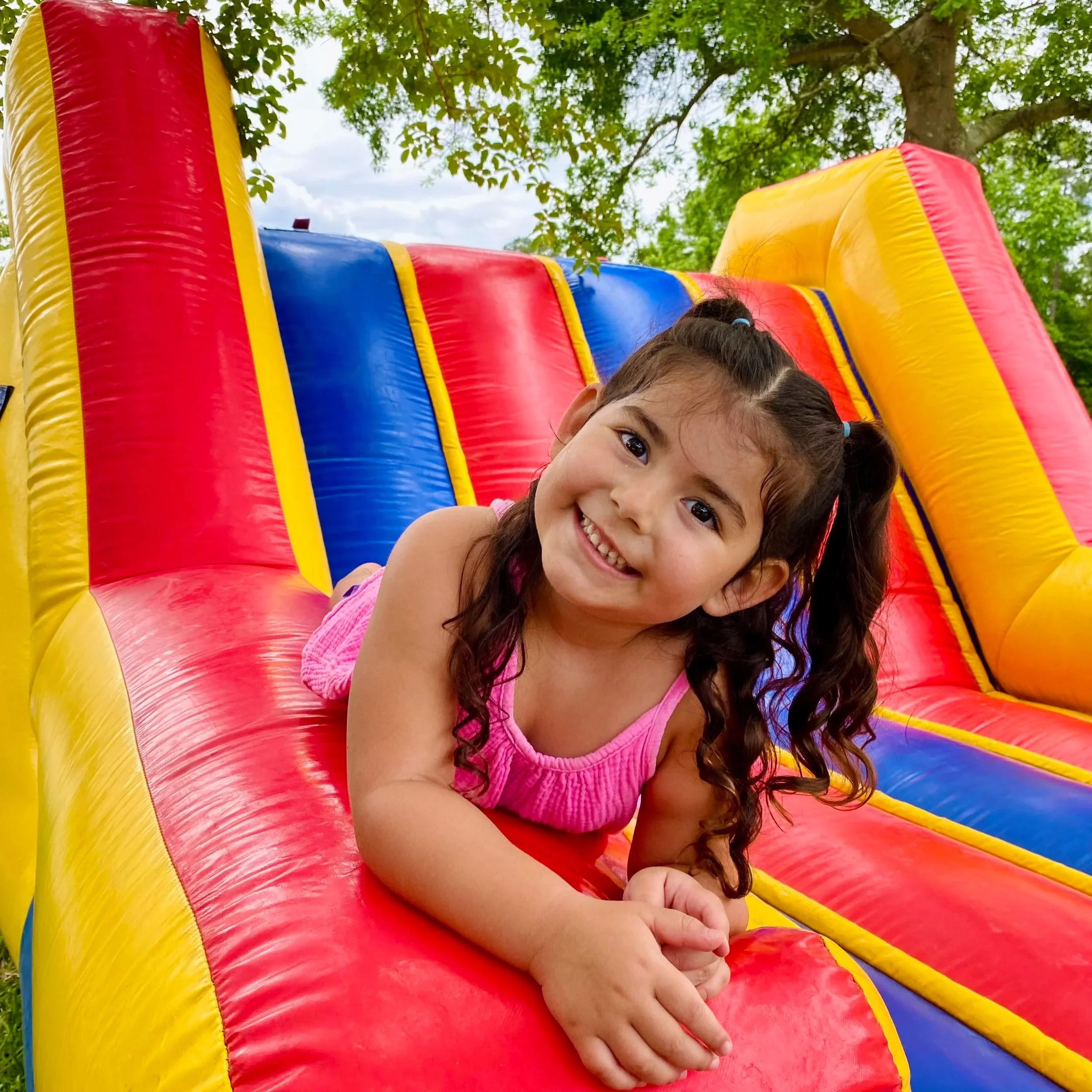Side-by-side inflatable race course for kids featuring rope challenges and slides, available from Bounce Brunswick.