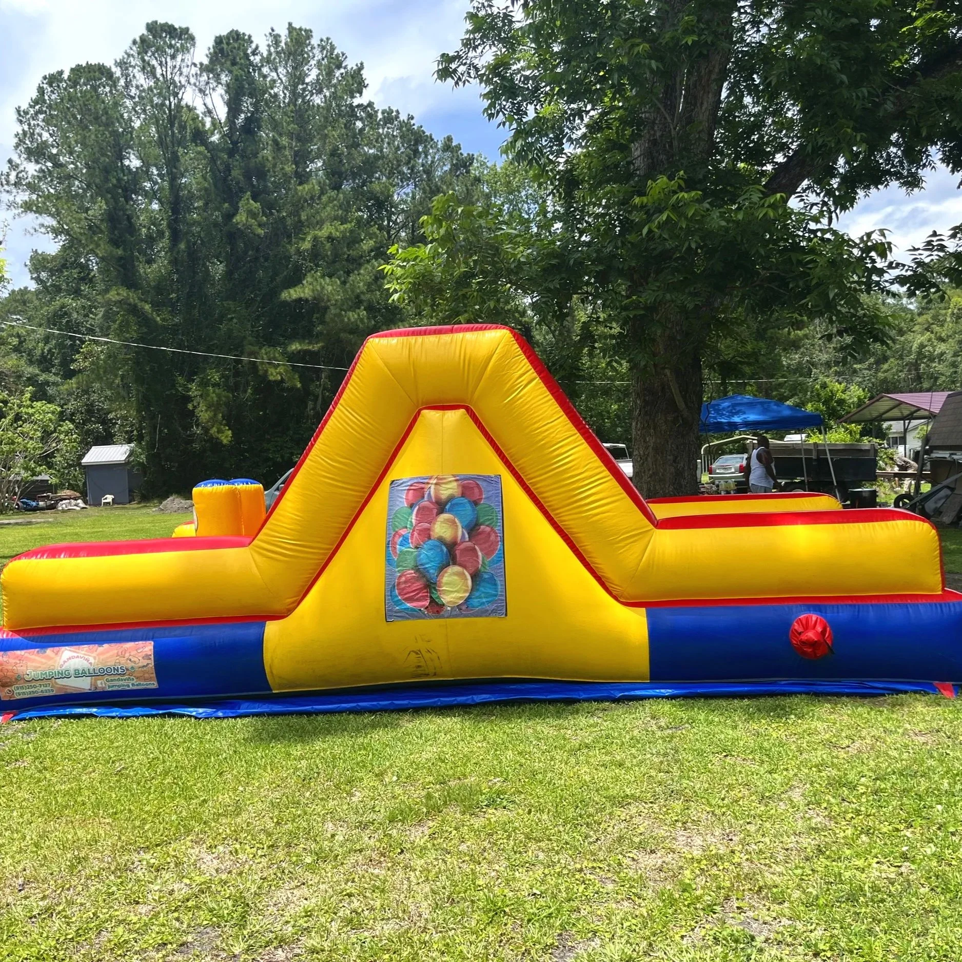 Inflatable racing obstacle course for younger kids, offering competitive fun in a compact backyard-friendly design.