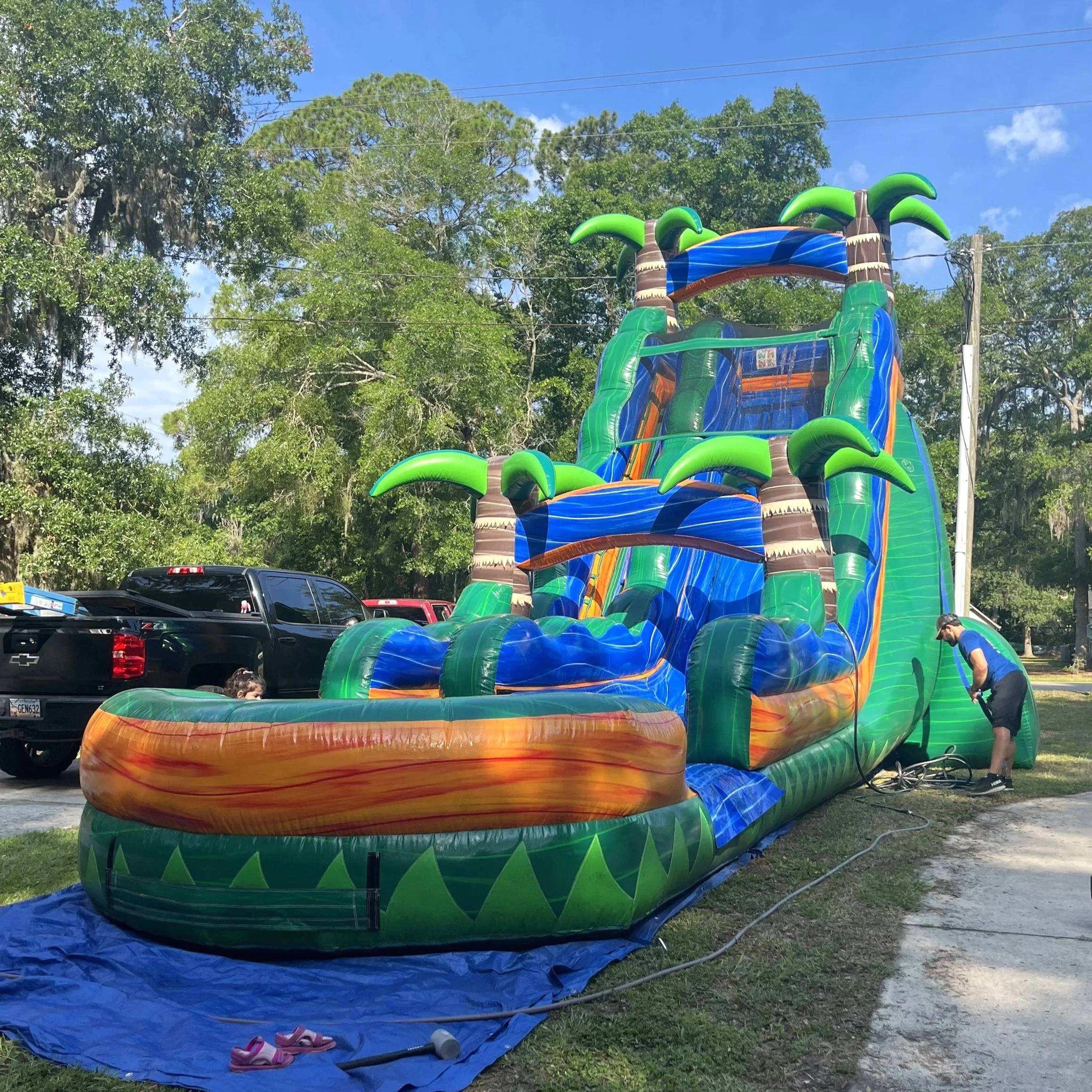 Swamp King water slide set up on grass in a residential backyard, ideal for summer parties and block events
