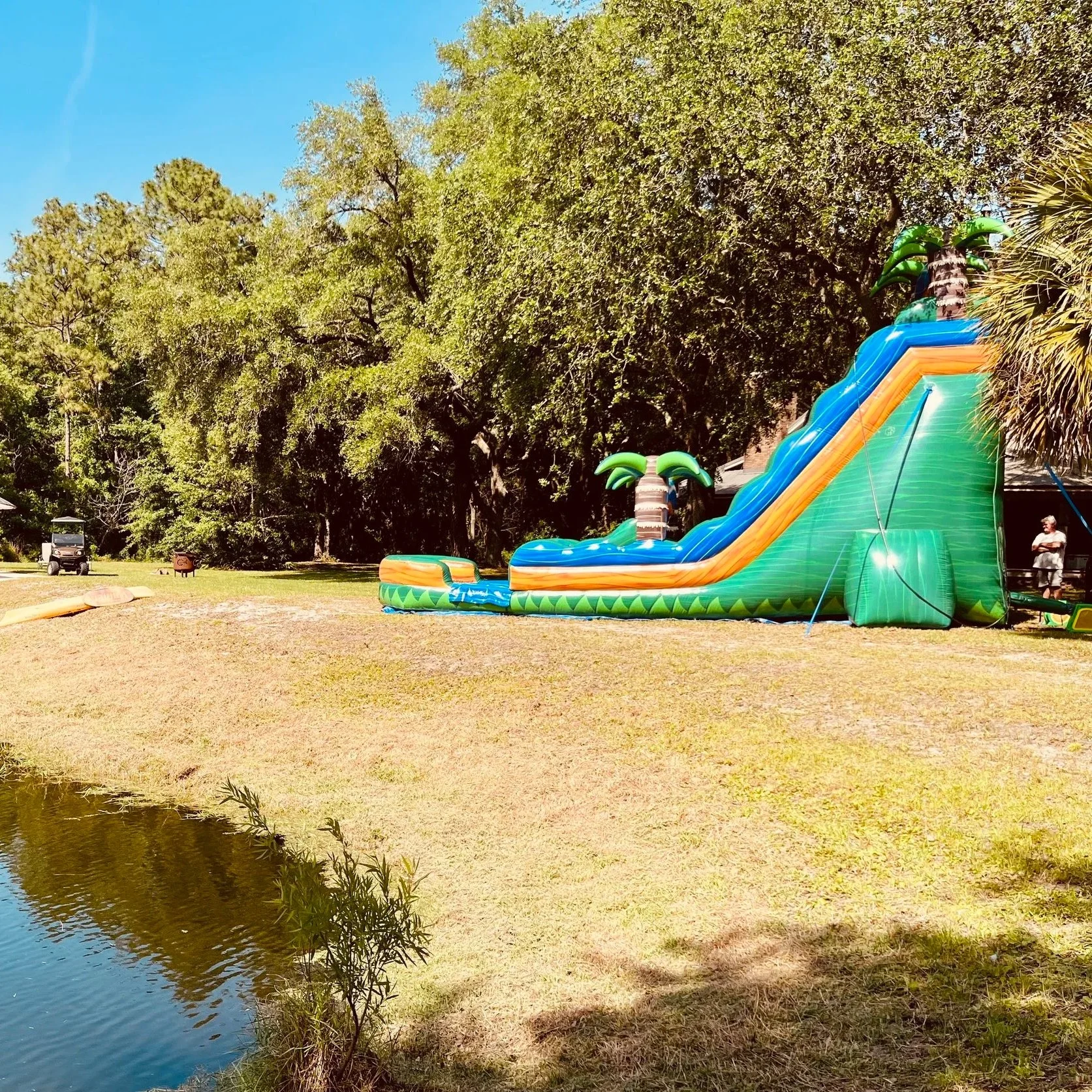 Tall inflatable water slide with long slide lane and deep splash pool available from Bounce Brunswick.
