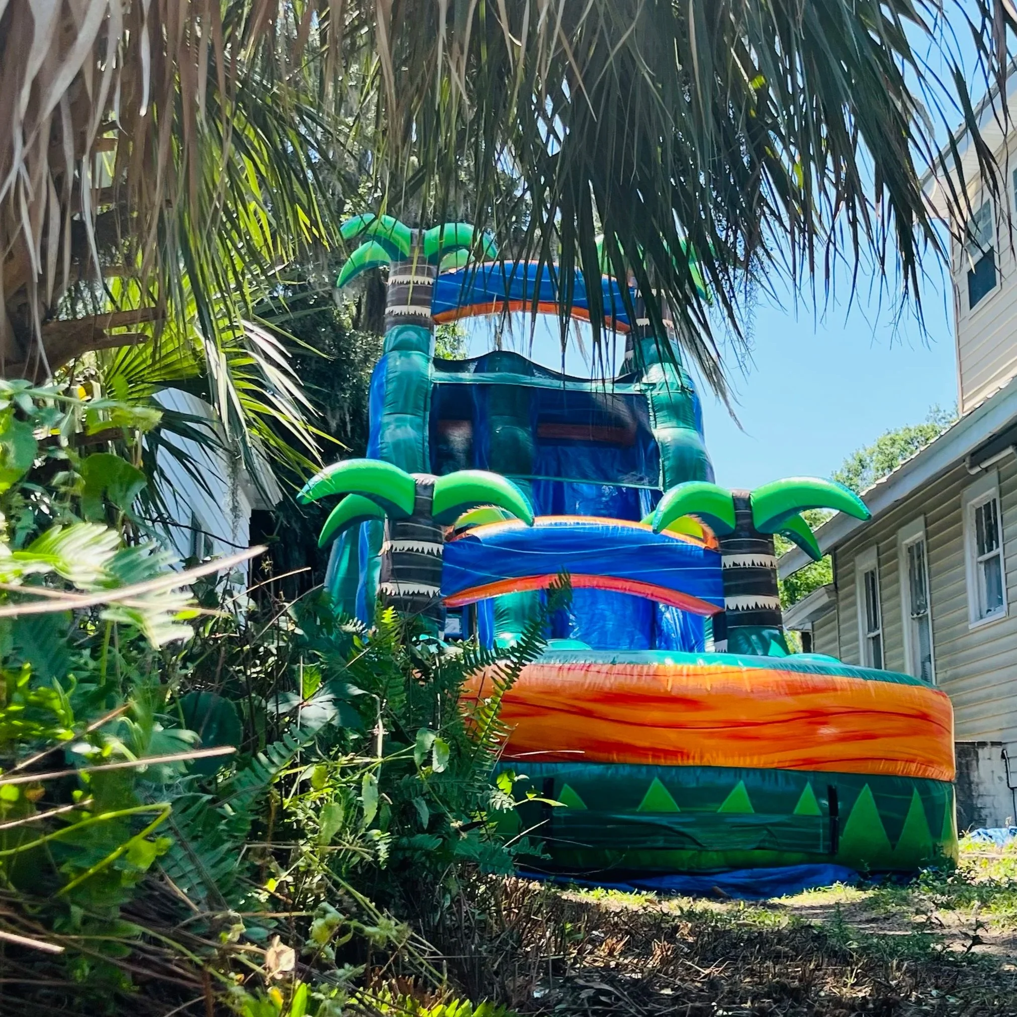 Outdoor inflatable water slide for large groups, featuring tropical colors and a fast, exciting ride.
