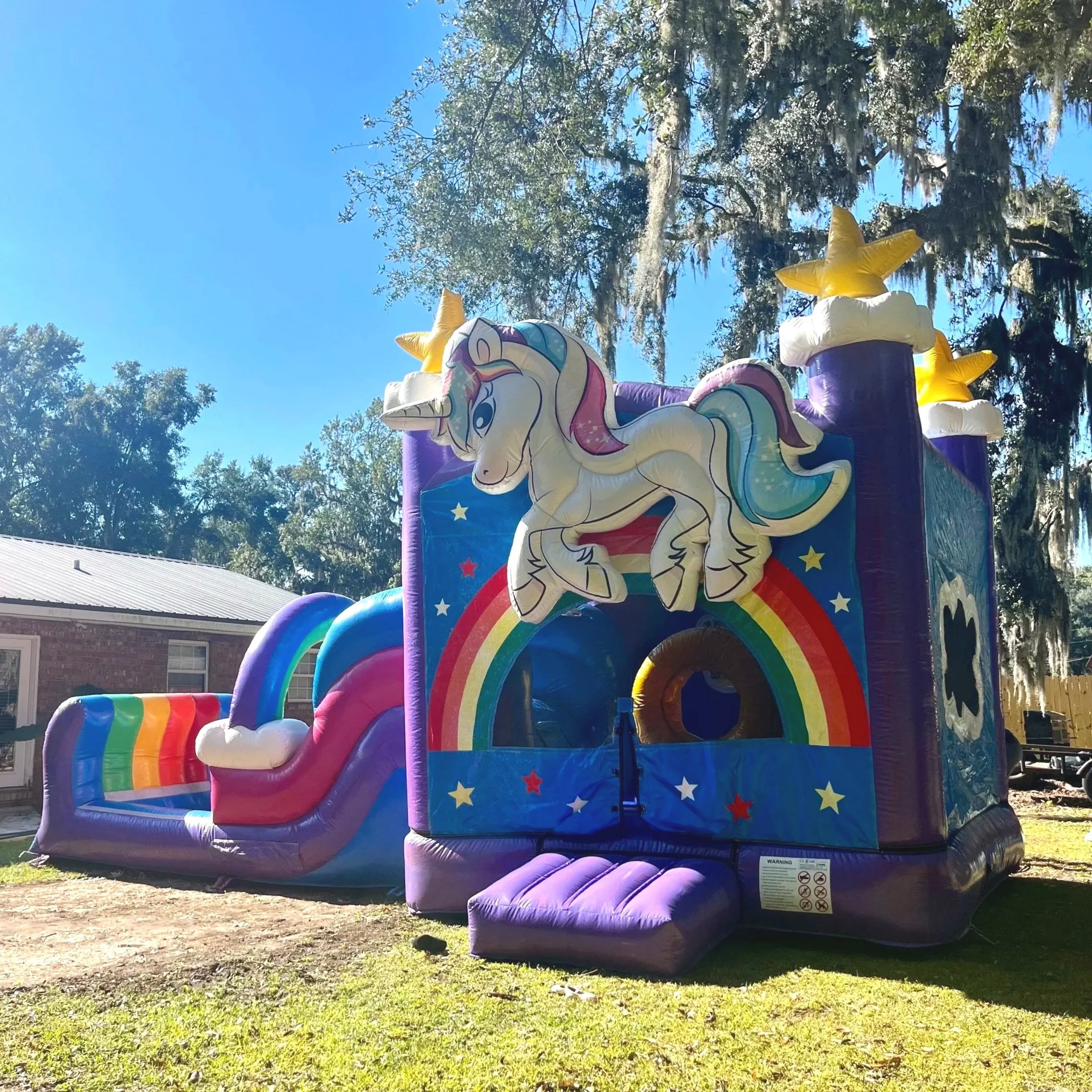 Unicorn Playland bounce house with slide adding bright color and magic to family celebrations in Coastal Georgia.