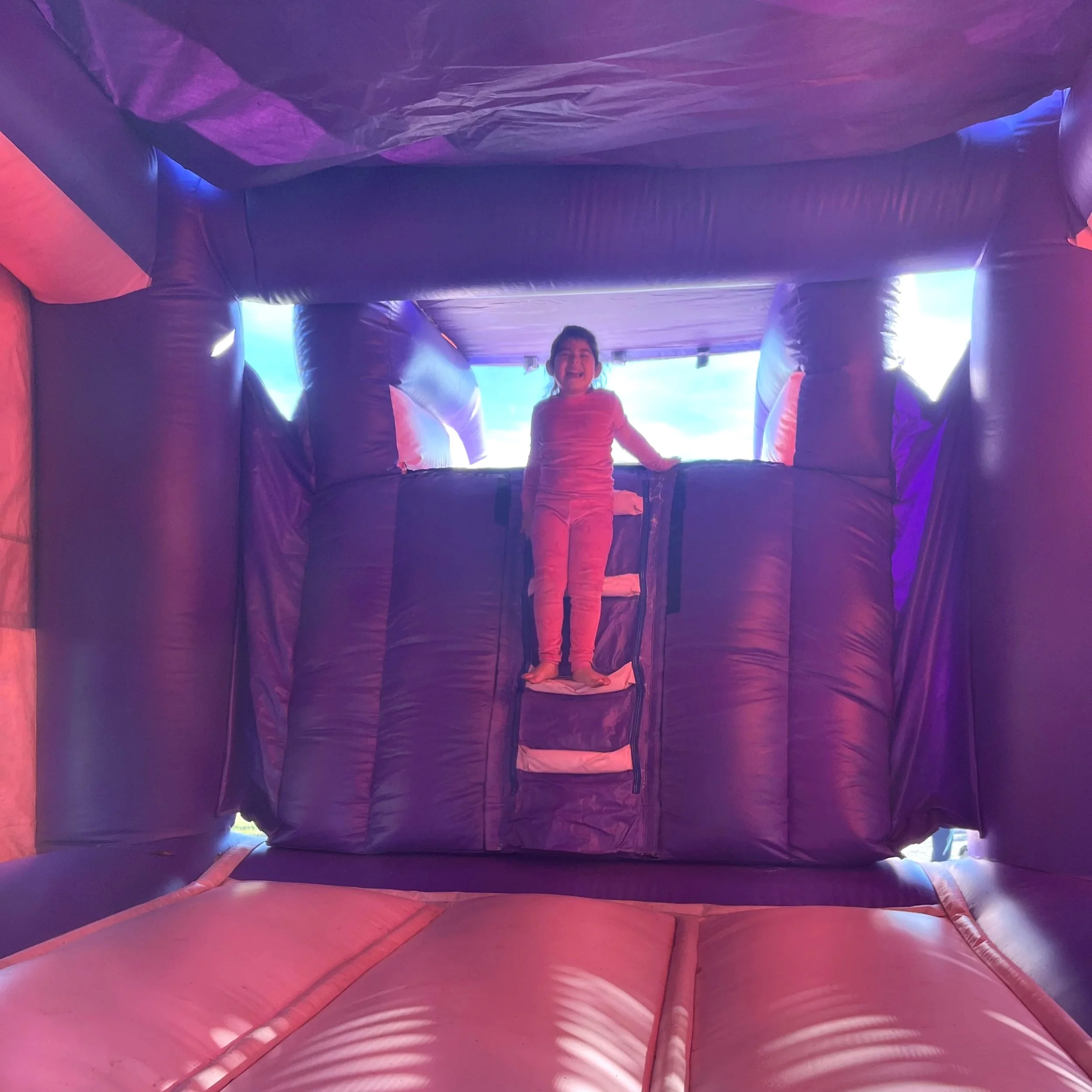Inside view of a clean inflatable bounce house showing the jumping area and interior mesh panels. Kitty Castle bounce house rental in Brunswick, Georgia, designed for safe indoor-style play.