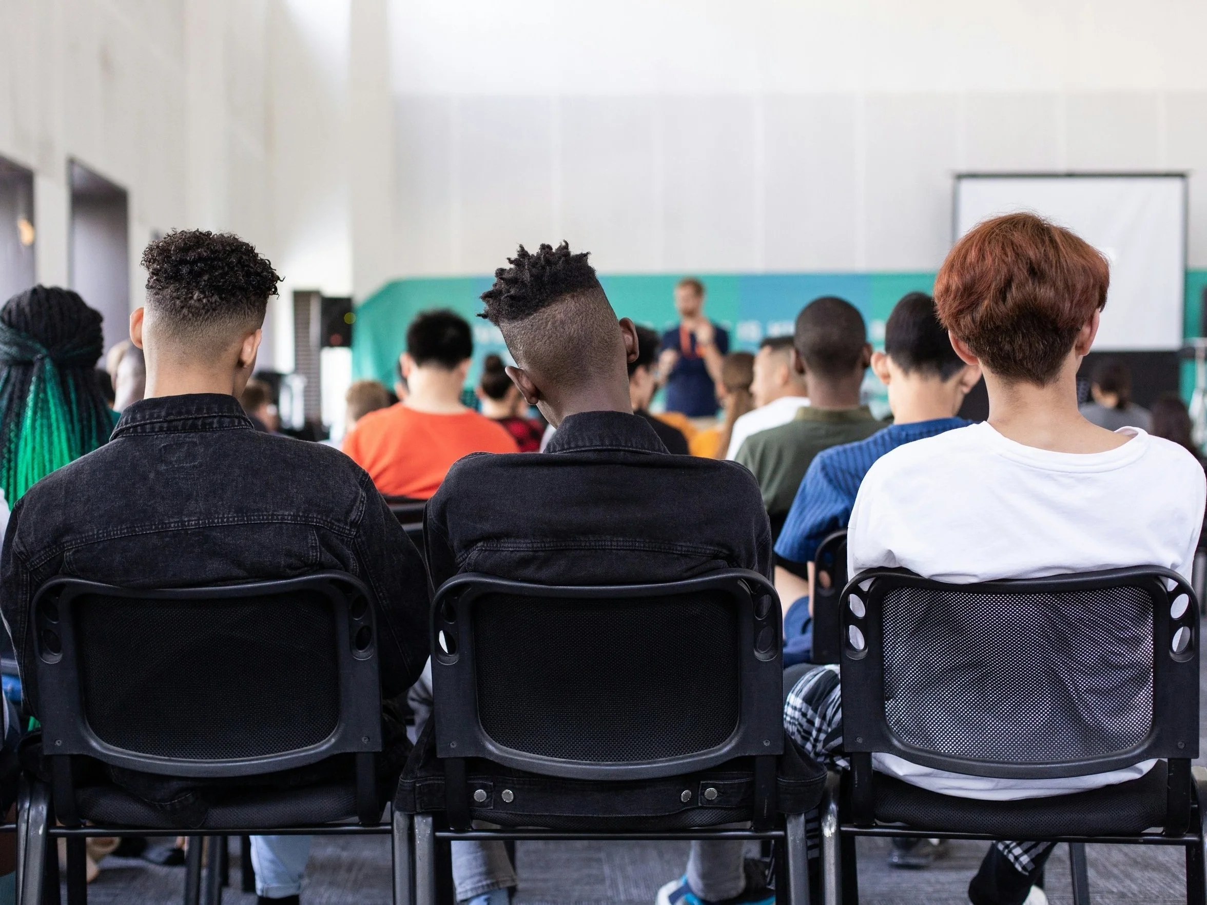 High school age boys sitting in a classroom facing an instructor. LifeWay Network's preventive education programs help young people avoid human trafficking