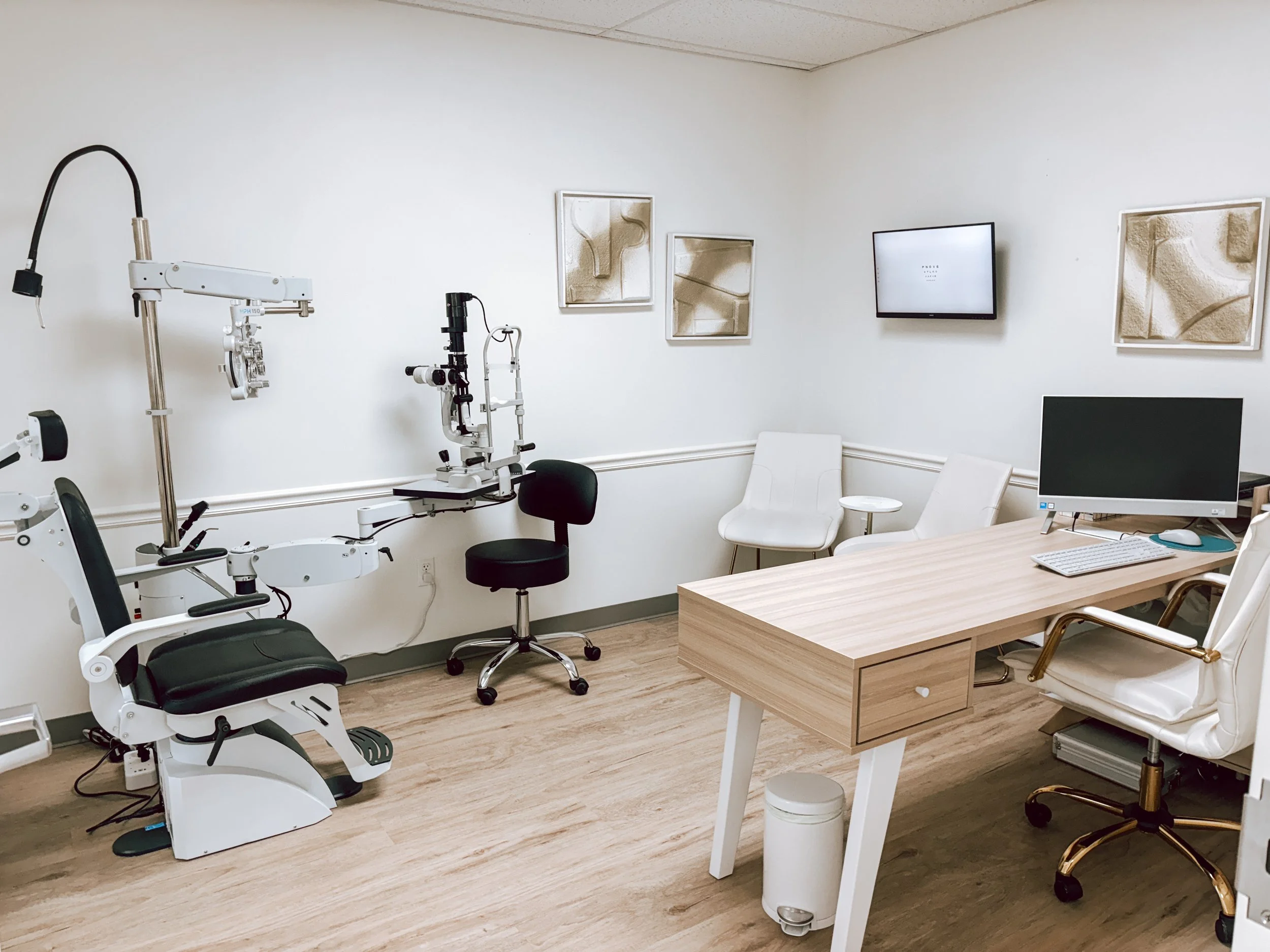 Exam room with desk and optometry equipment