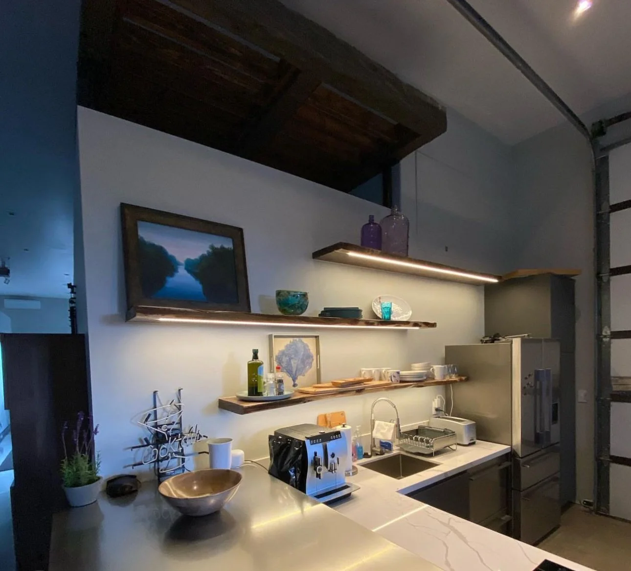 Custom lighting in floating shelves by Marmolejo Electric