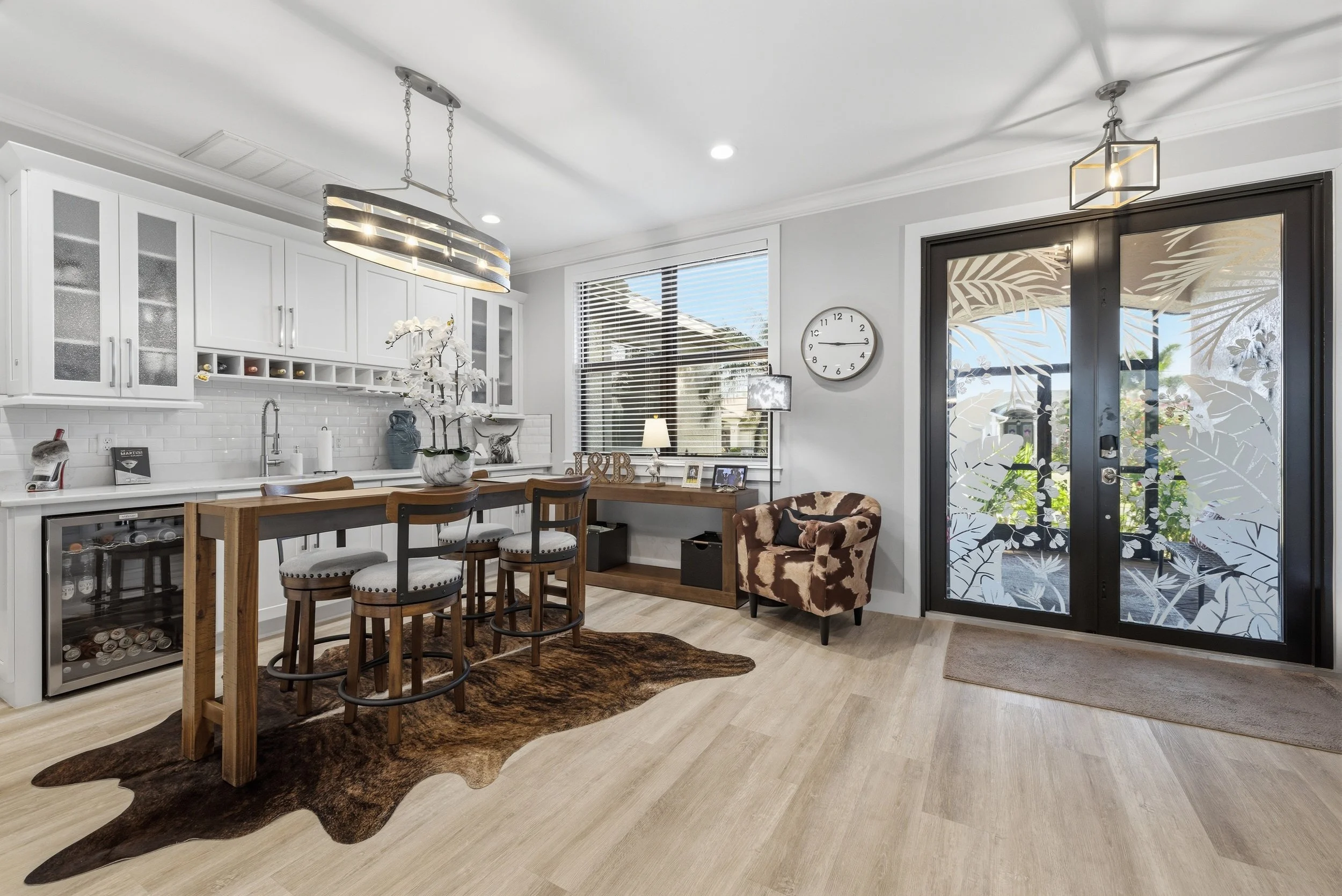 Kitchen and dining area with island seating and chandelier