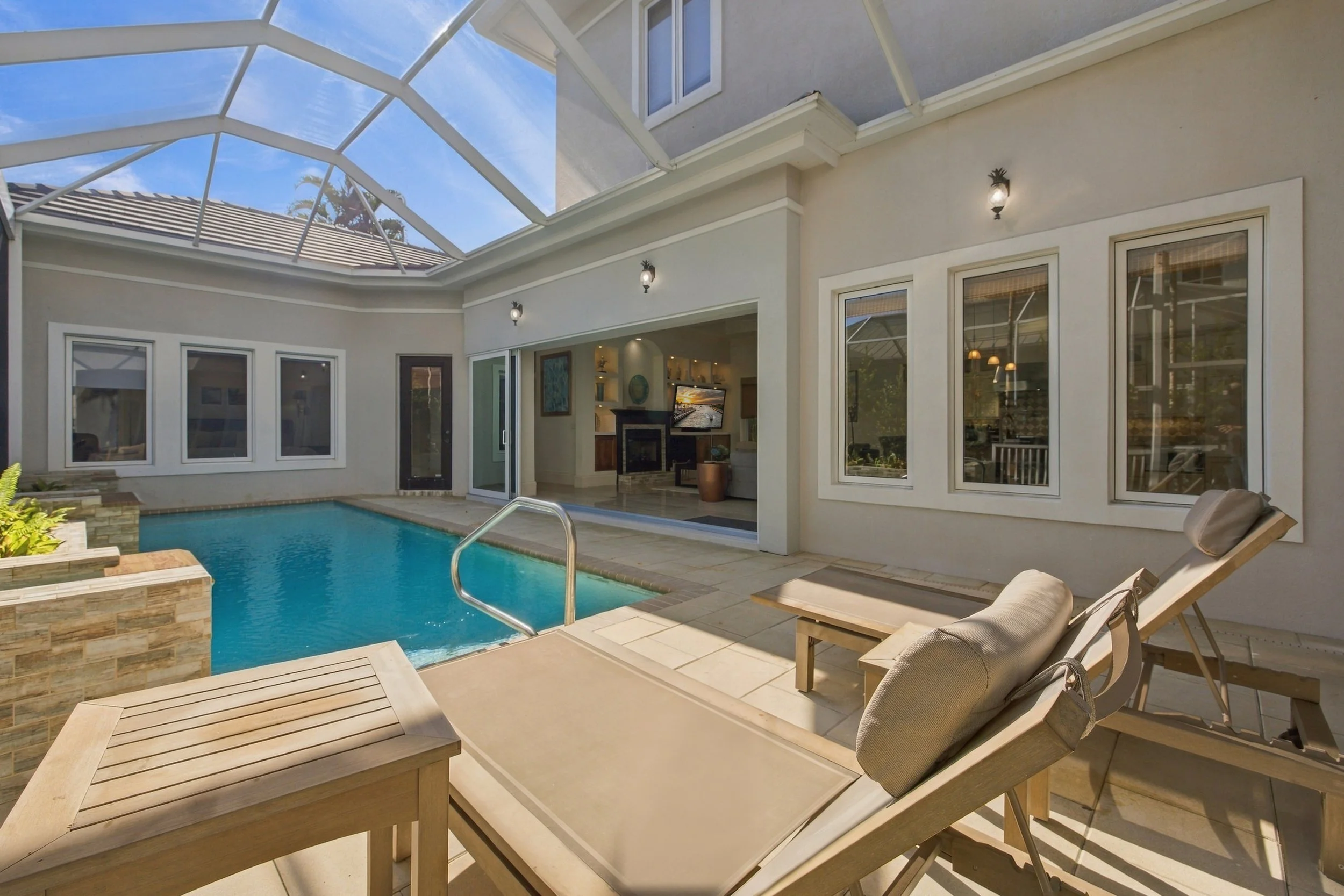 Screened pool and patio with lounge chairs
