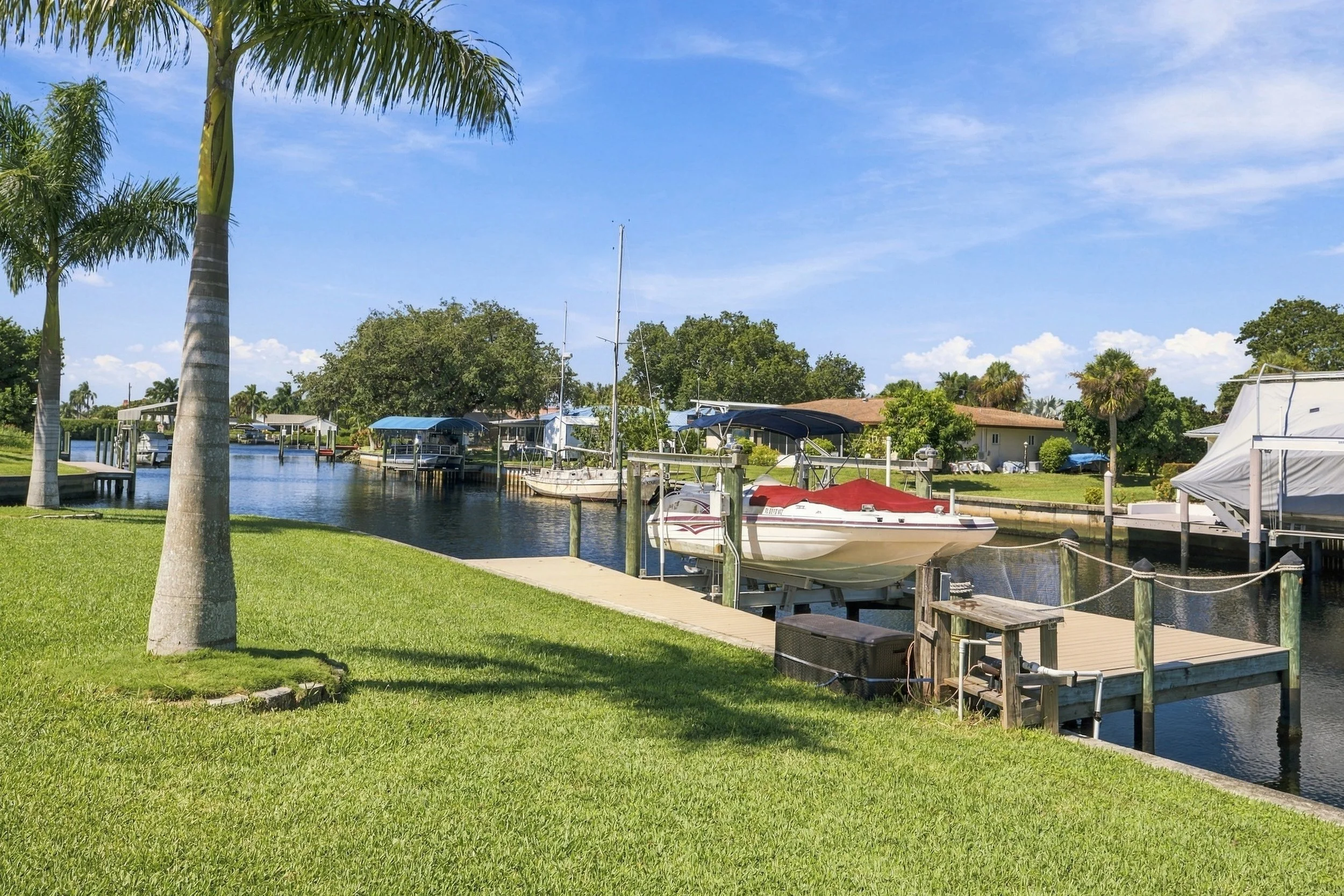 Canal with boat docks and palm trees, common in Fort Myers waterfront neighborhoods