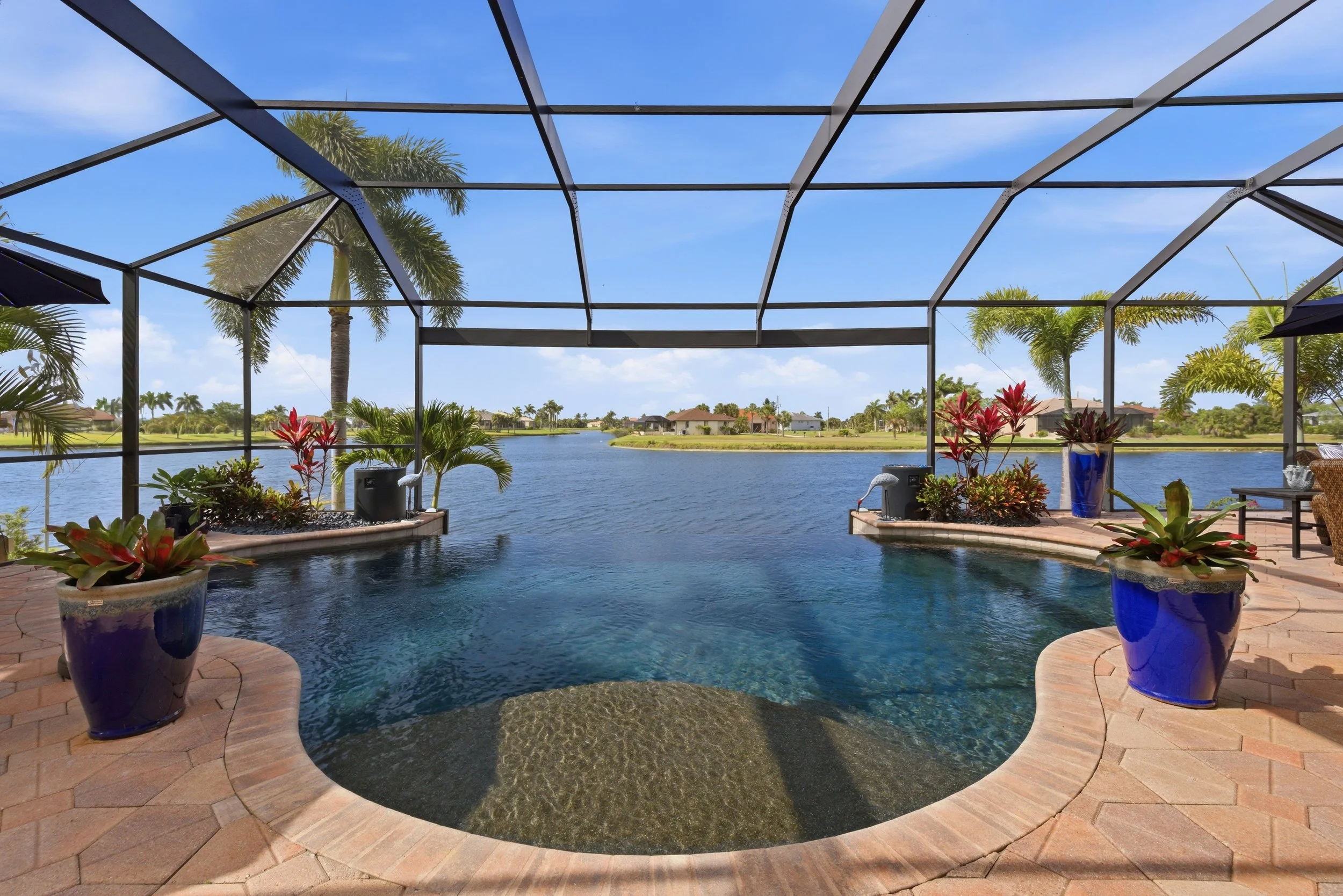 Screened pool and lanai overlooking a lake, a popular setup in Cape Coral homes