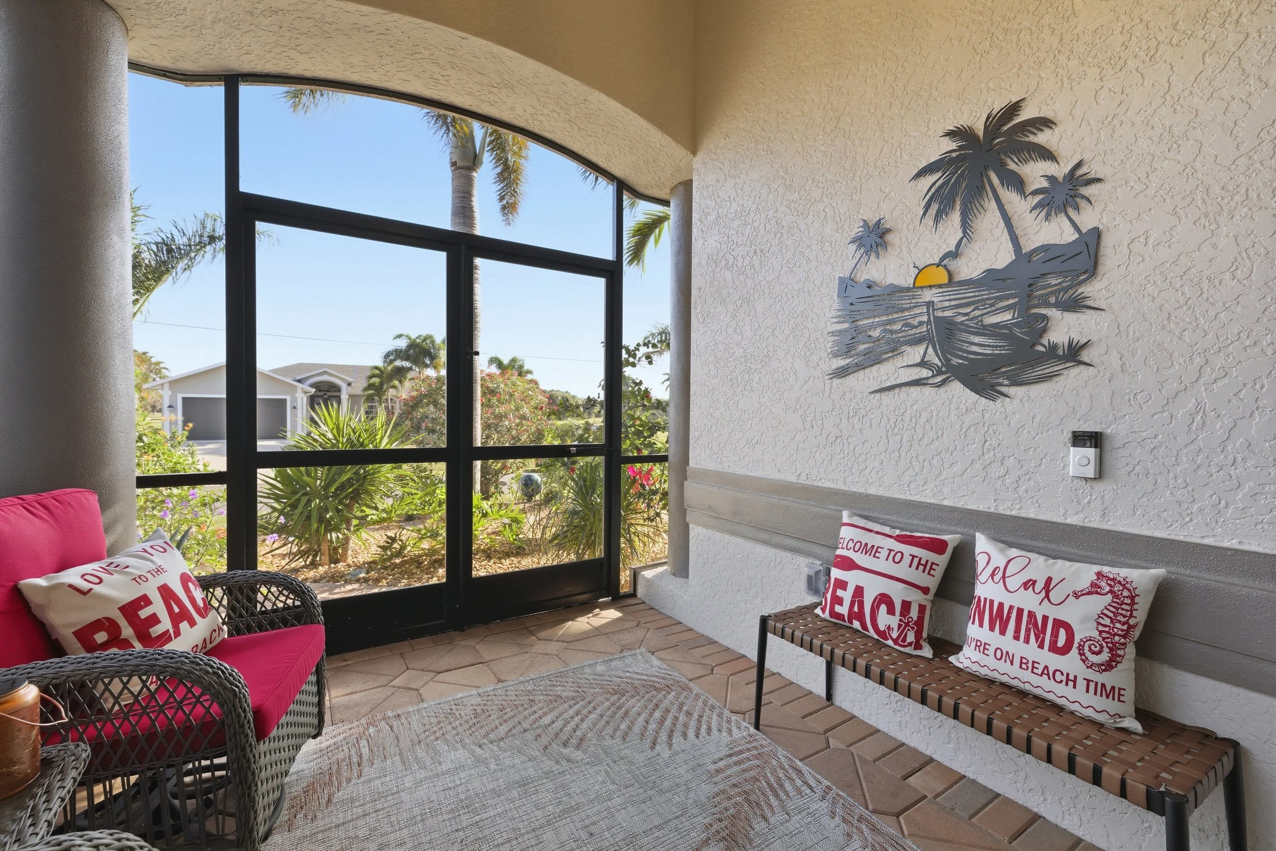 Corner with red chair, plaid pillows and palm tree art