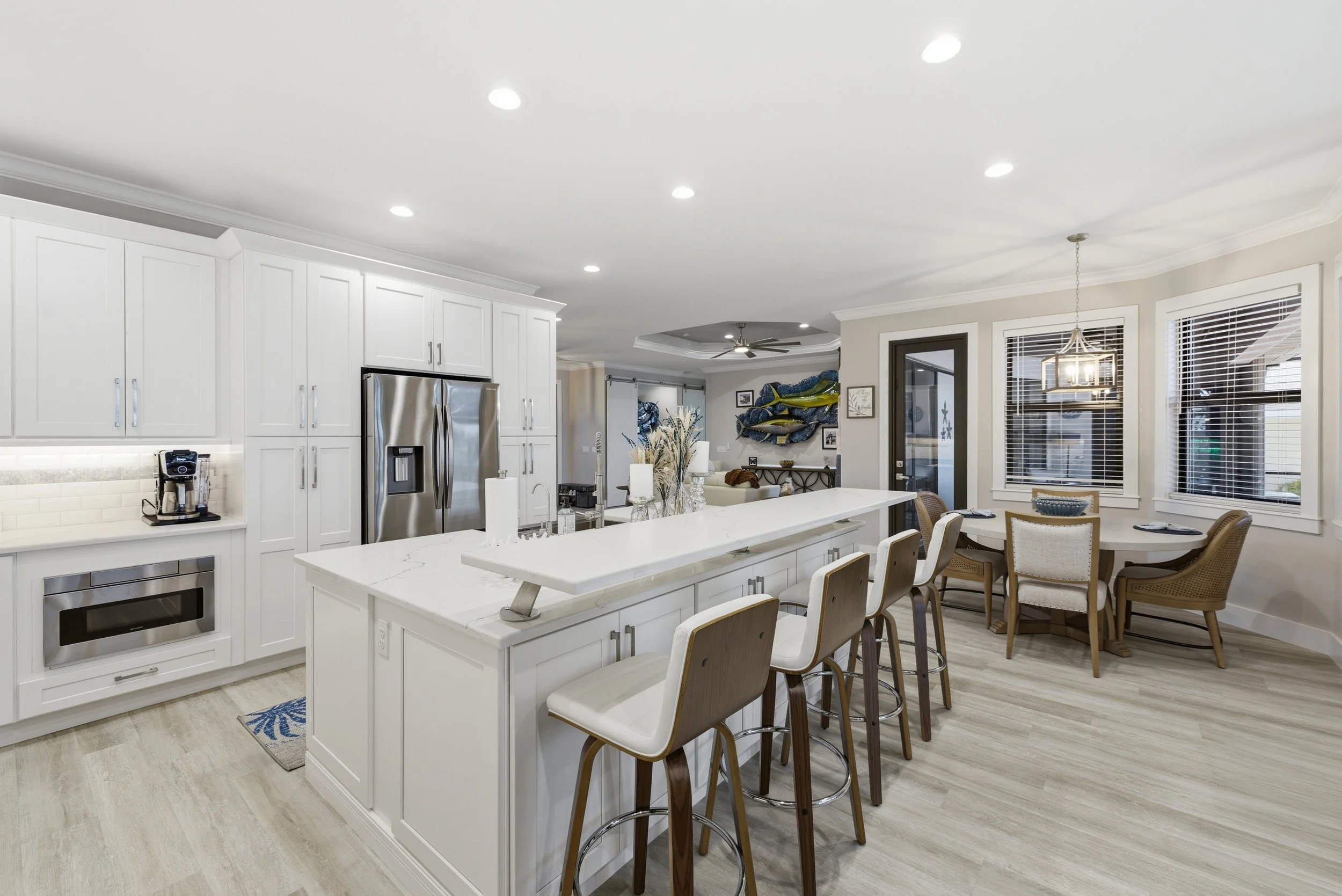 Open kitchen with breakfast bar and dining area