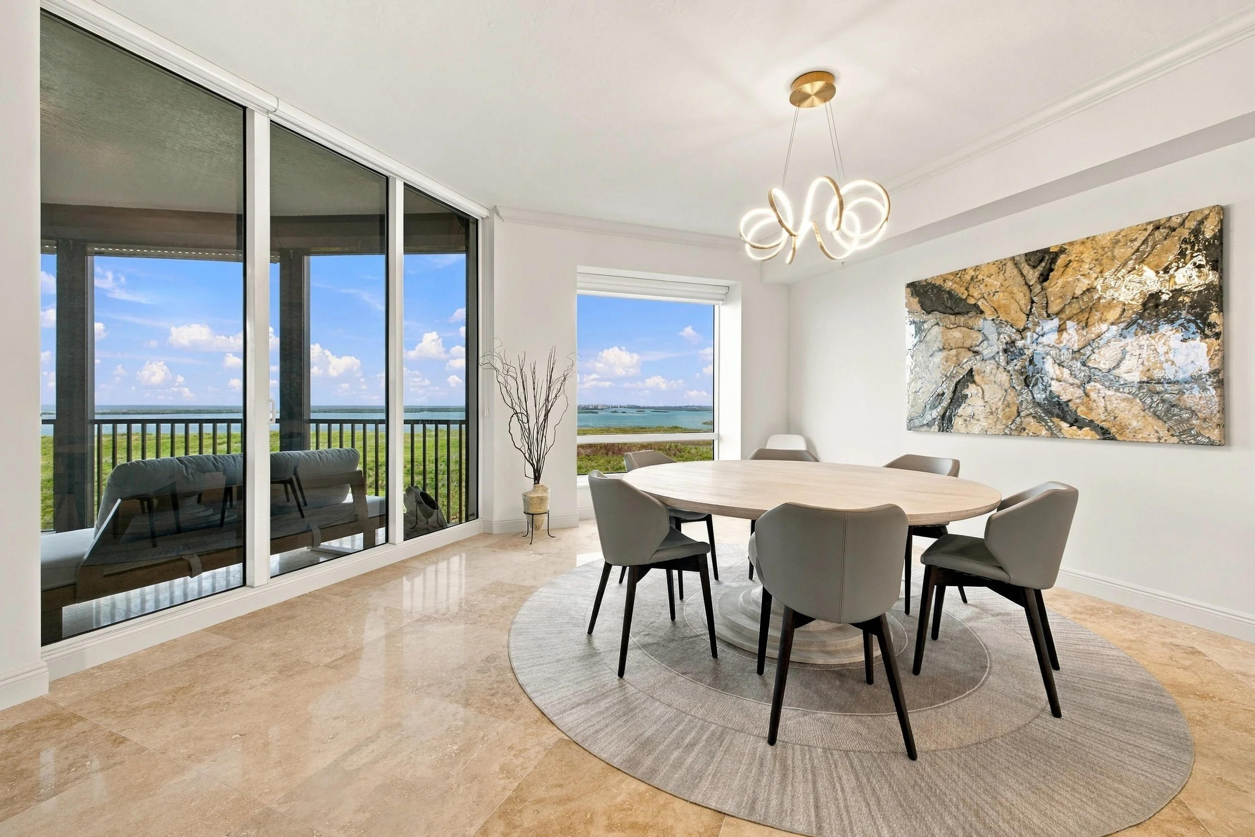 Dining area with round table and floor-to-ceiling windows