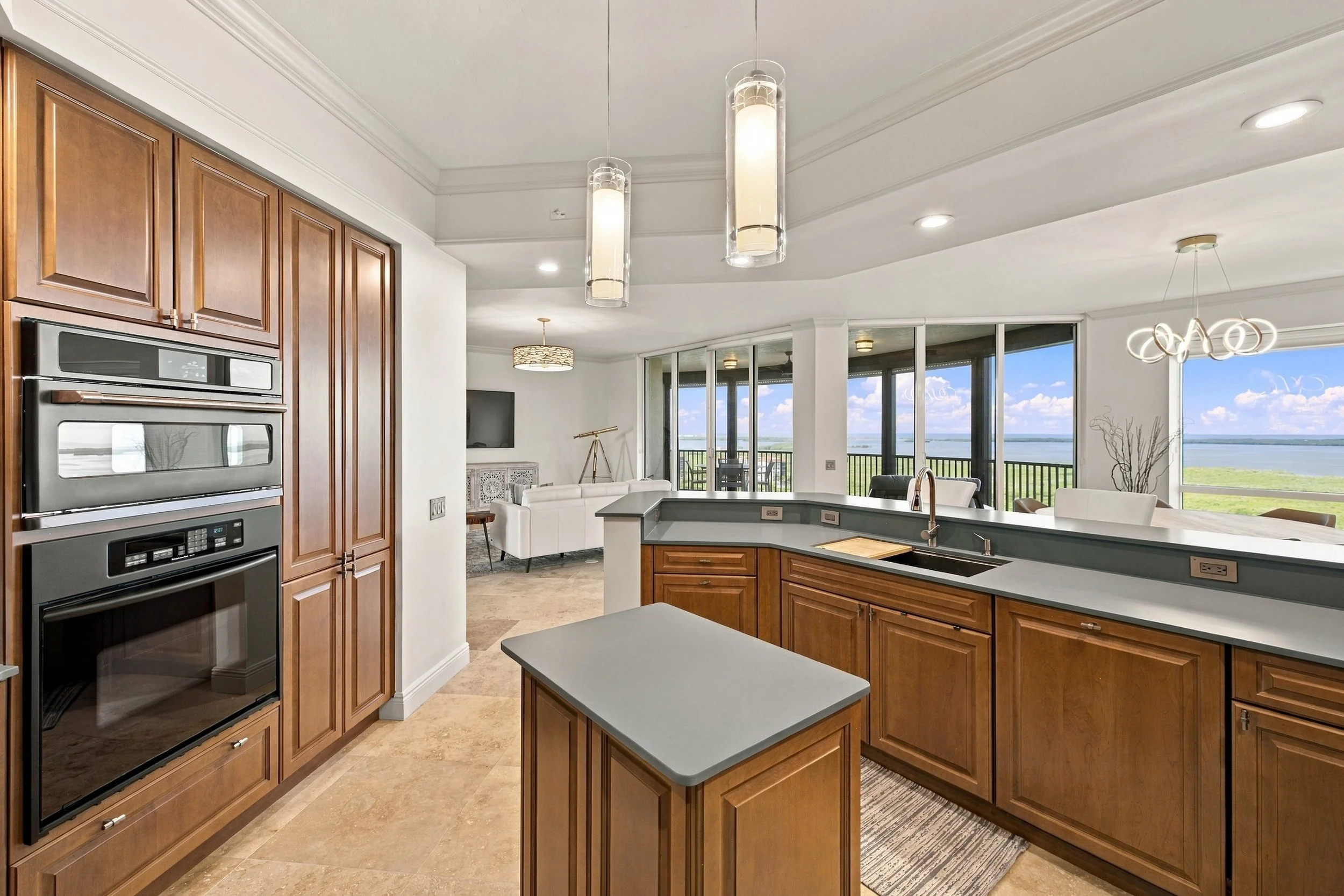 Kitchen with wood cabinets, island and wall ovens