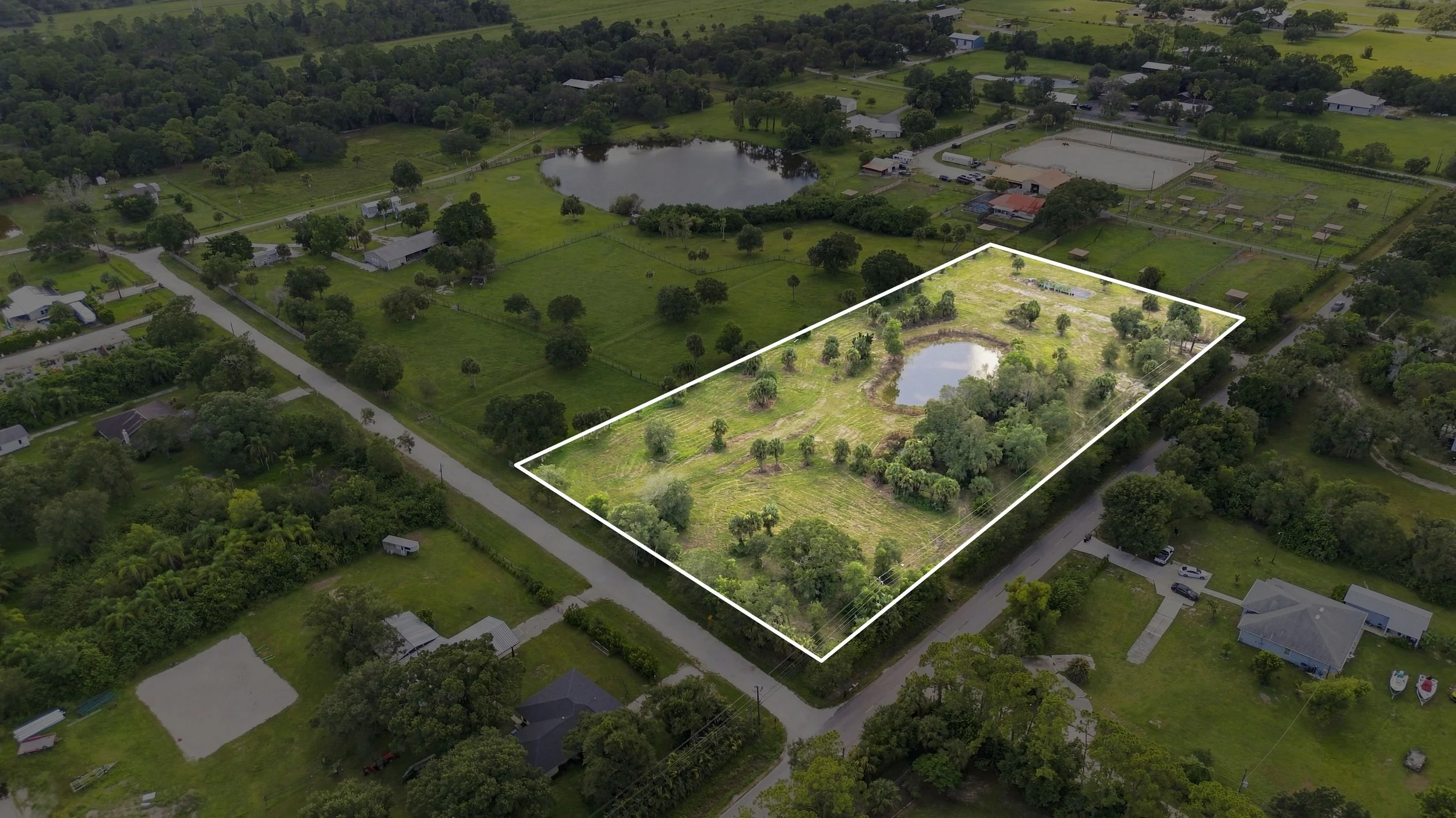 Aerial drone photo with property line outline over a wooded Southwest Florida lot
