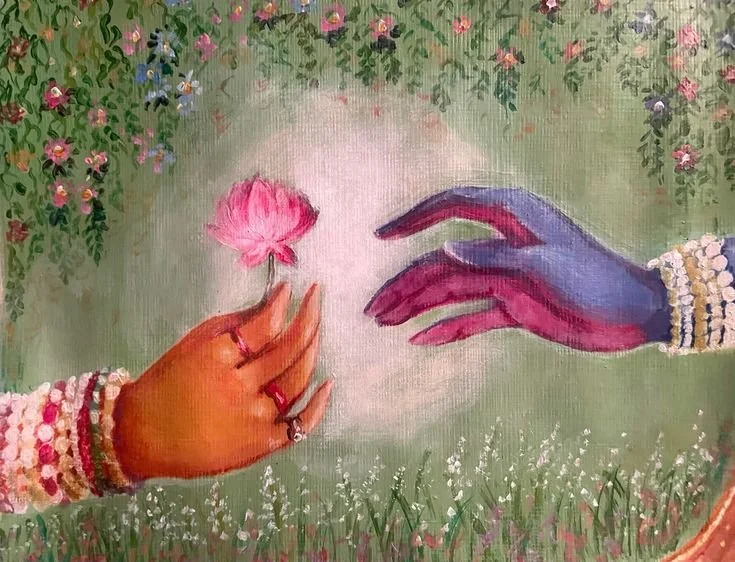 Two hands are reaching towards each other over a grassy field with pink and purple flowers. One hand is adorned with colorful bracelets and rings, and the other with a pearl bracelet. The hand on the left is holding a pink flower.