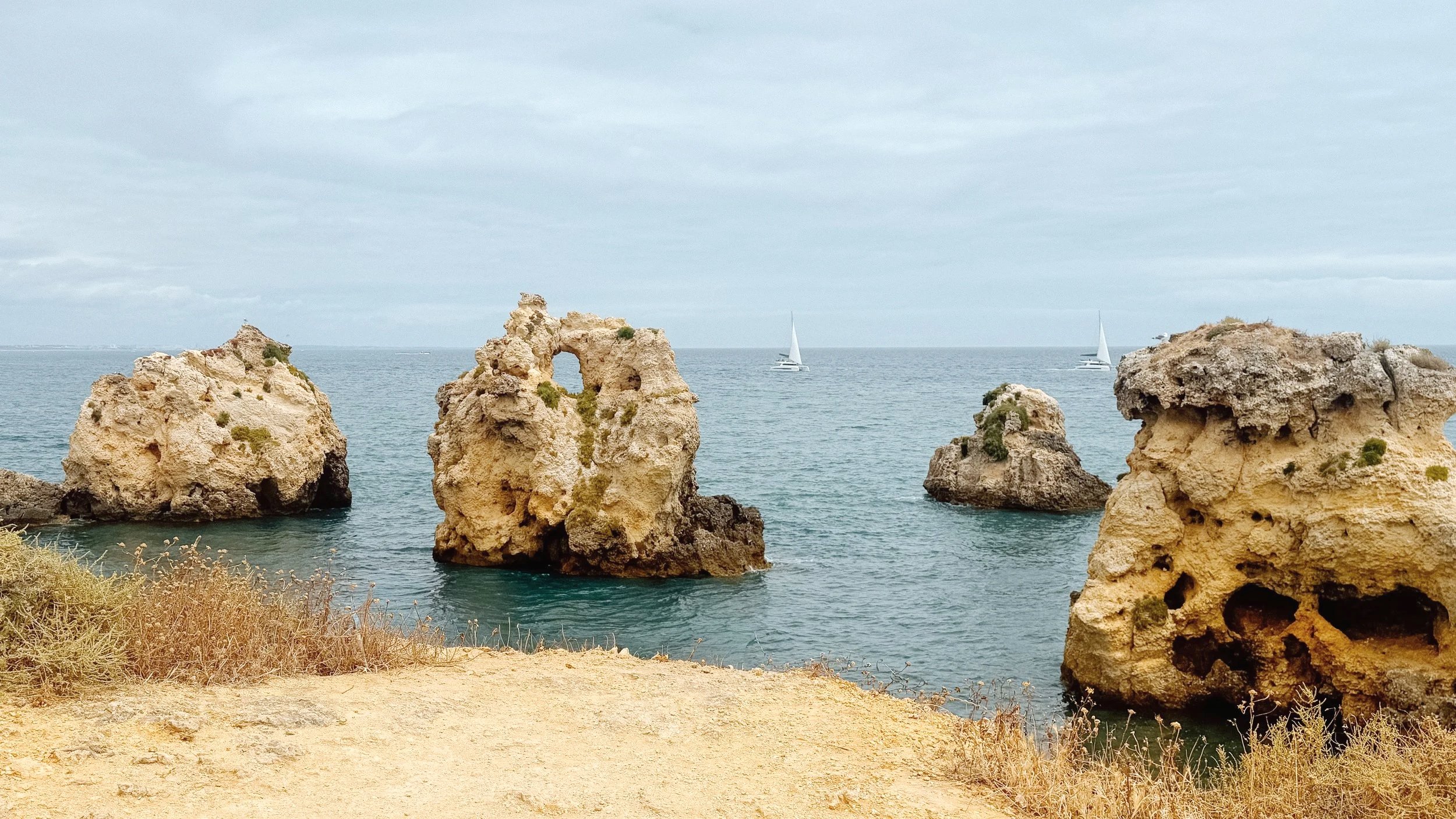 Soft golden light over a quiet beach on the Algarve coast in Portugal