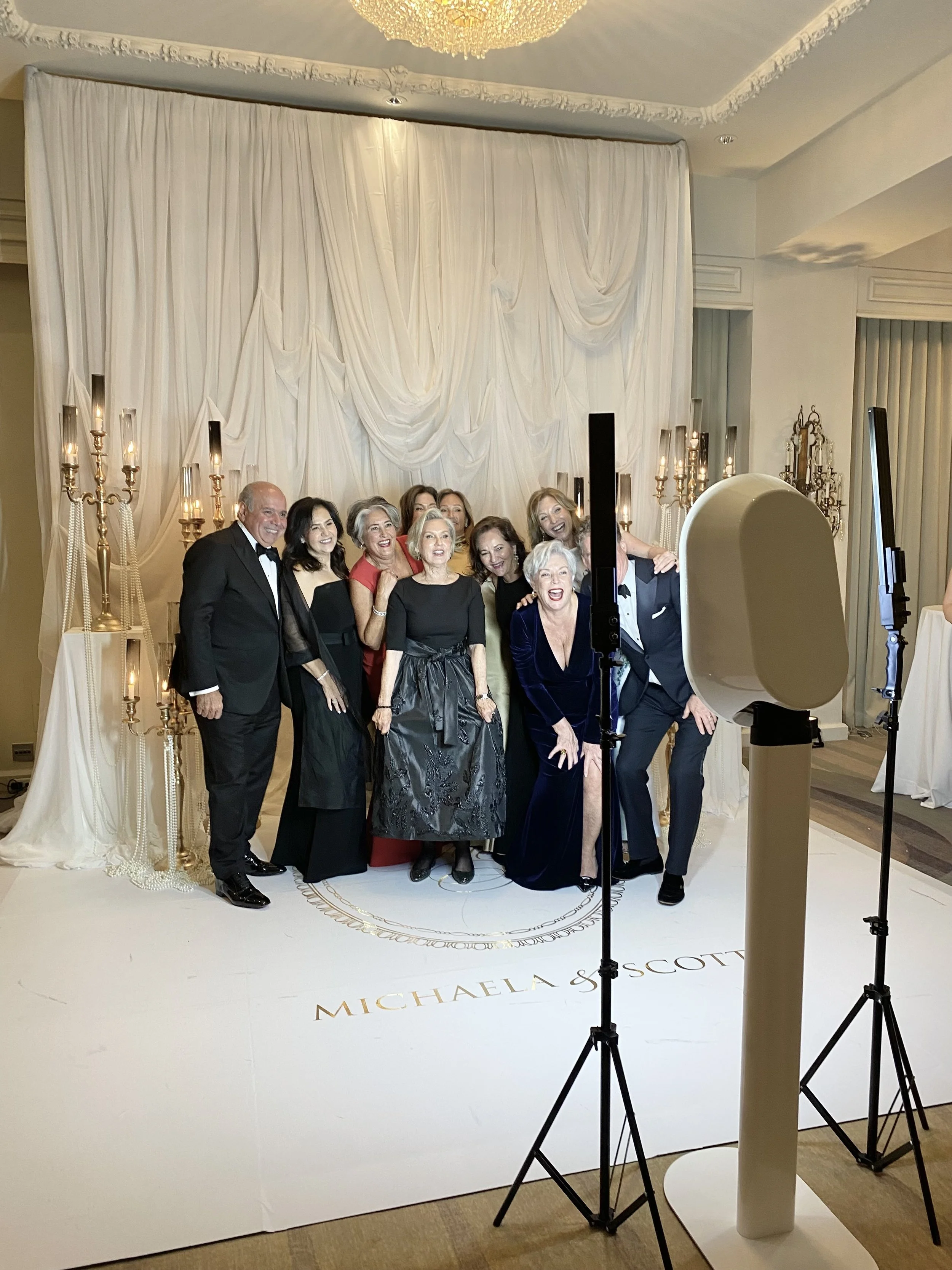Elegant wedding photo booth setup in Toronto with a floral backdrop, perfect for capturing special moments.