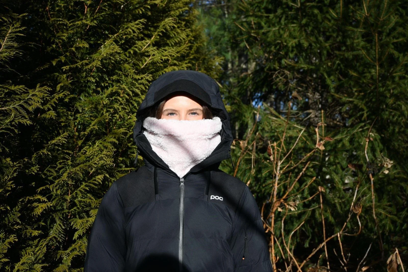 Rider in a black hooded jacket wearing the Baby Pink Sherpa neckie pulled up under their eyes