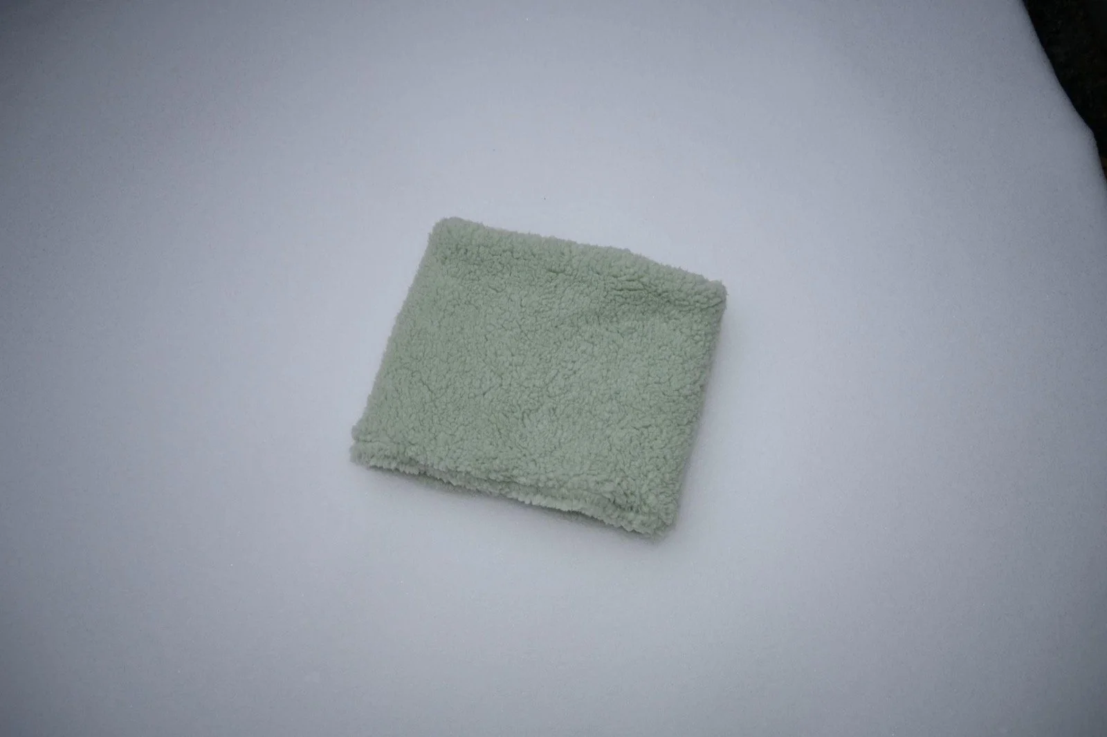 Minty Sherpa Neckie laid flat on a light gray background