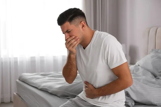 Man experiencing nausea and stomach discomfort seeking acupuncture support in Brisbane
