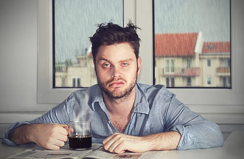 Tired person in the morning showing the impact of poor sleep.