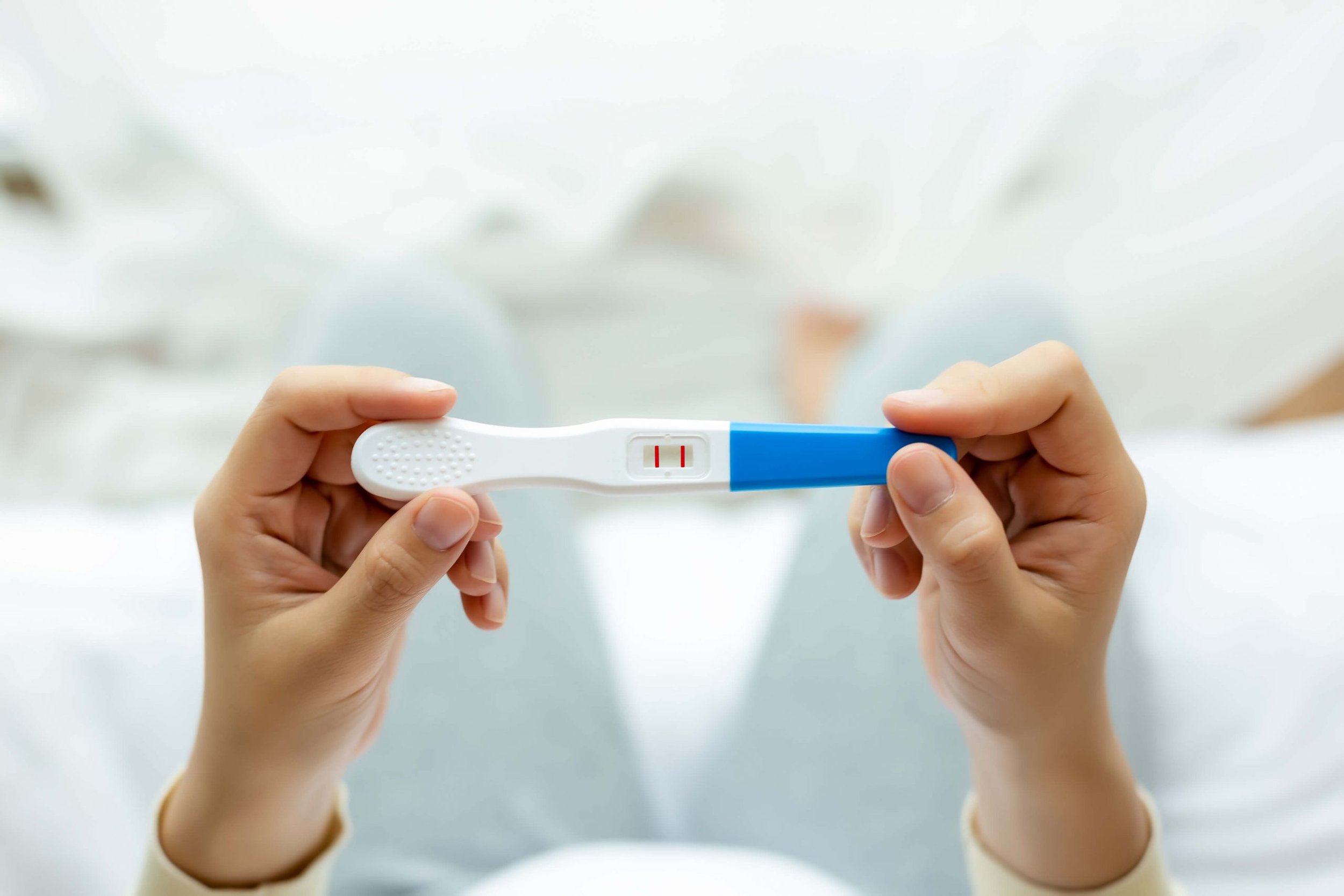 Positive pregnancy test representing fertility and preconception support in Brisbane.